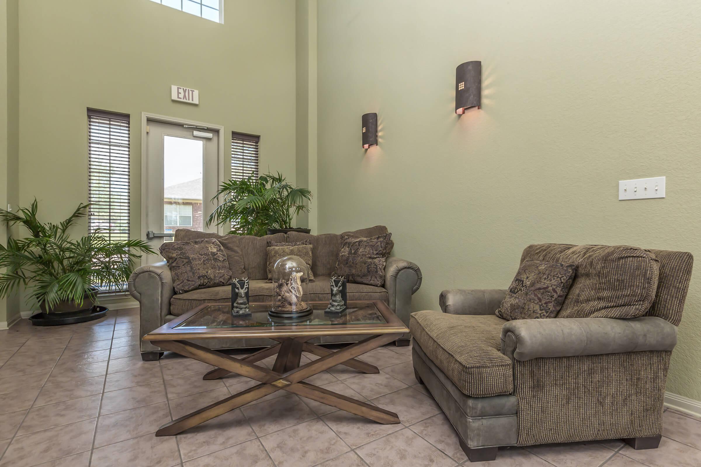 a living room filled with furniture and a large window