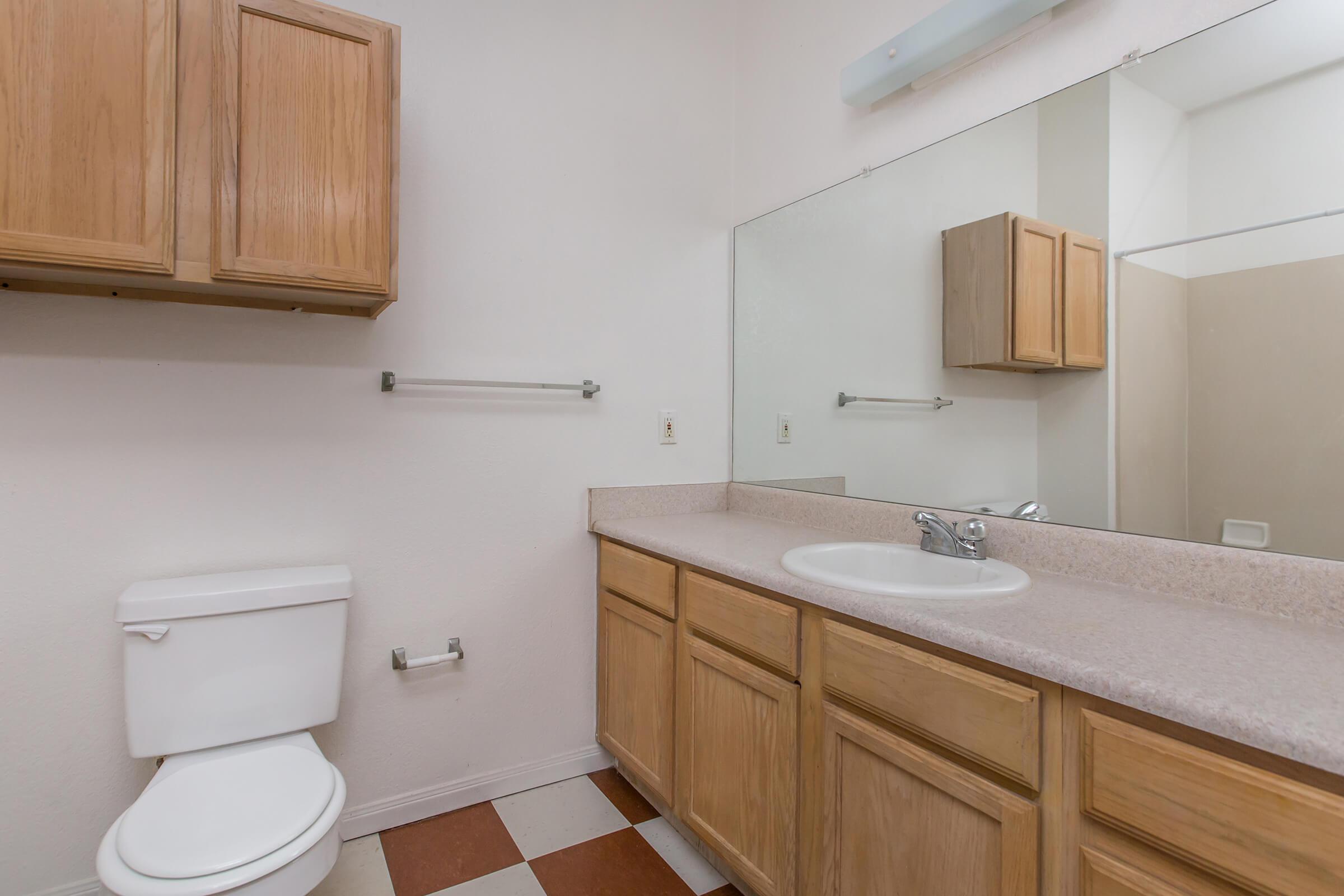 a kitchen with a sink and a mirror