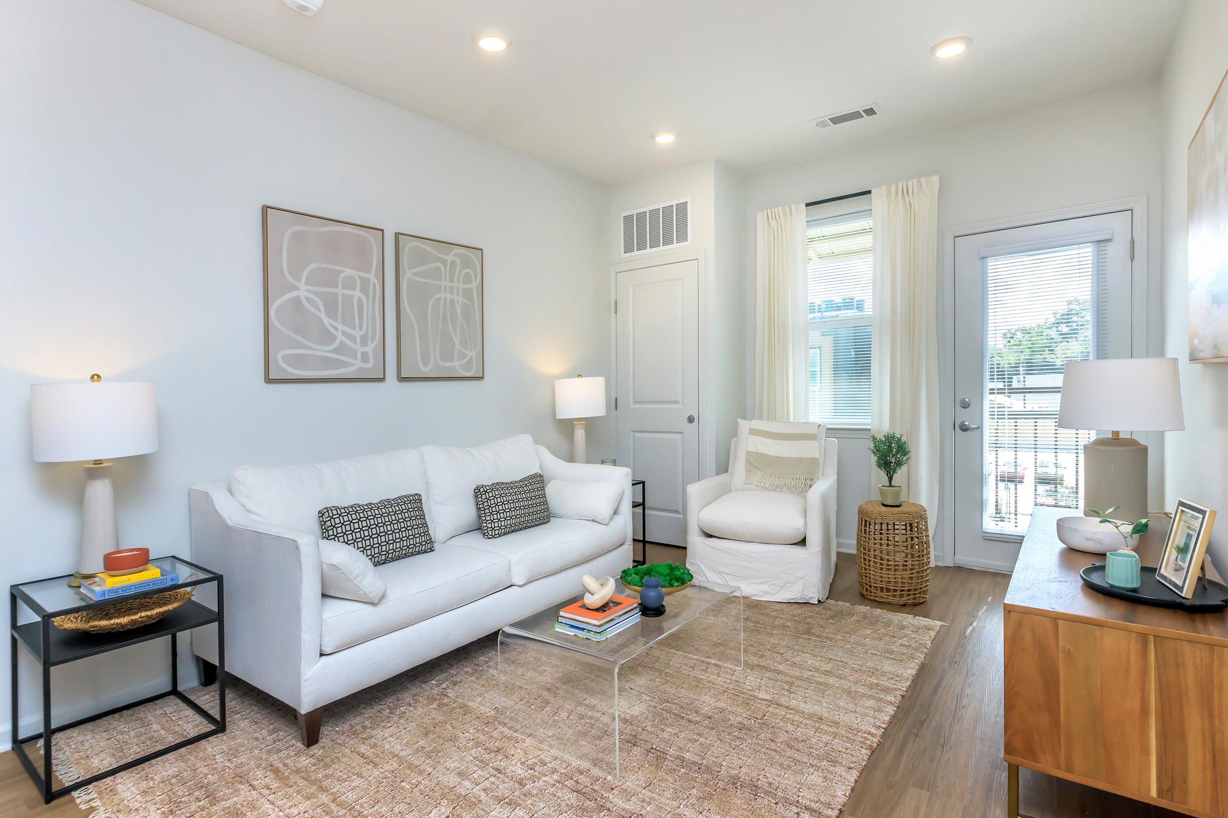 a living room filled with furniture and a large window