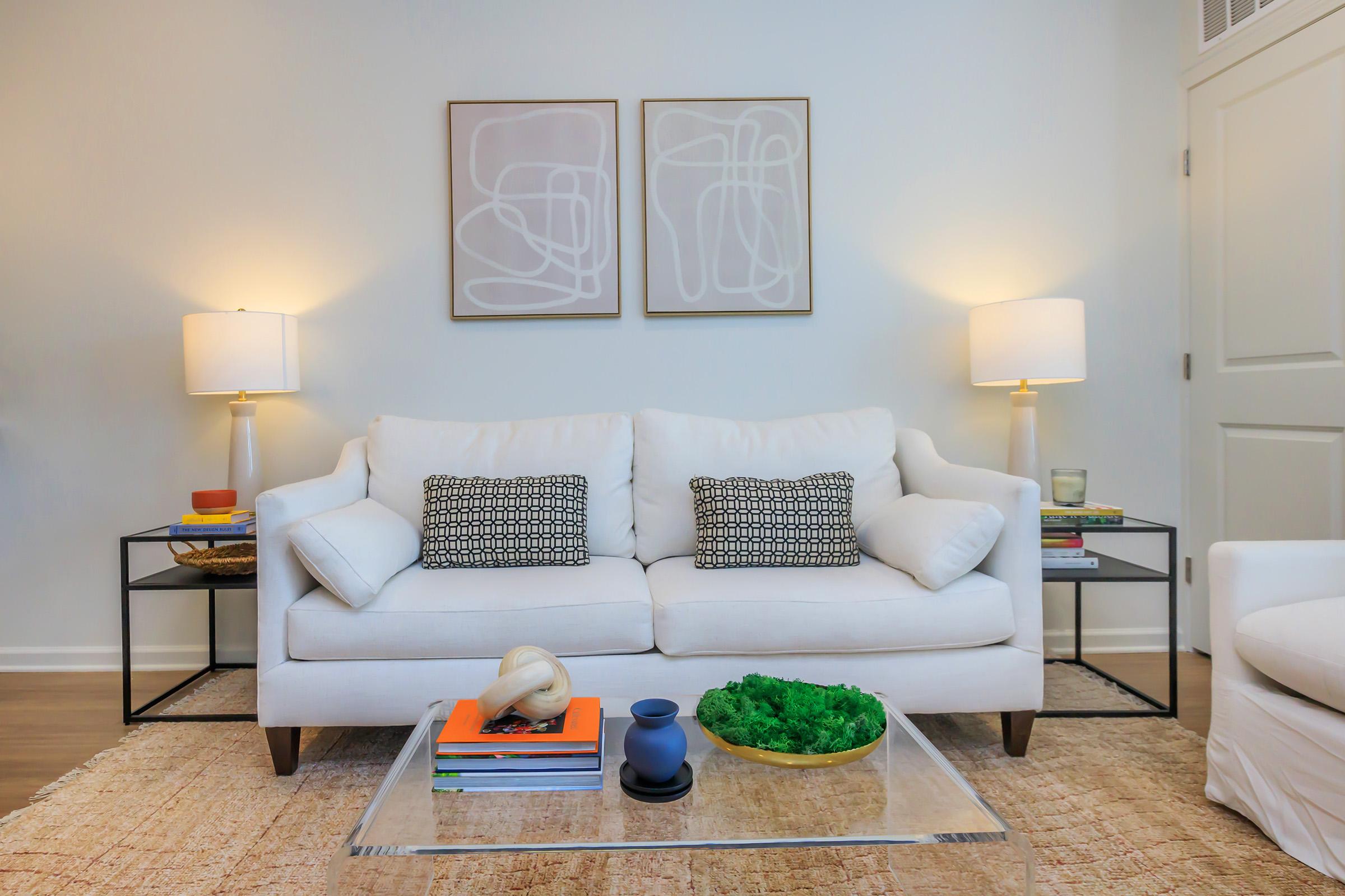 a bedroom with a bed and a chair in a living room