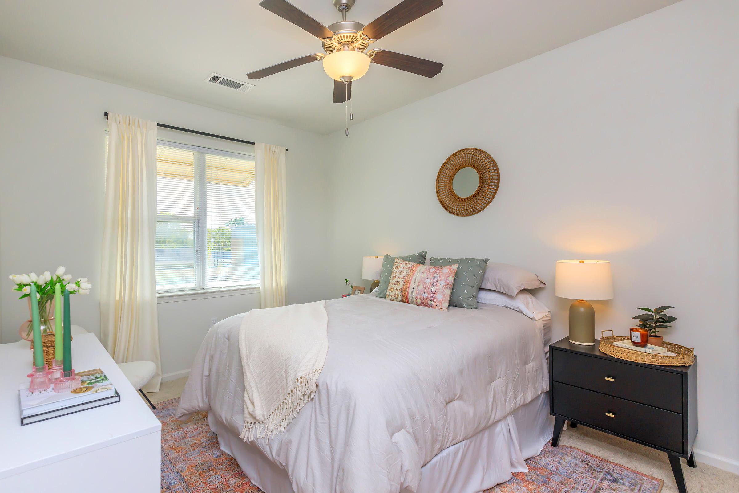 a bedroom with a bed and desk in a room