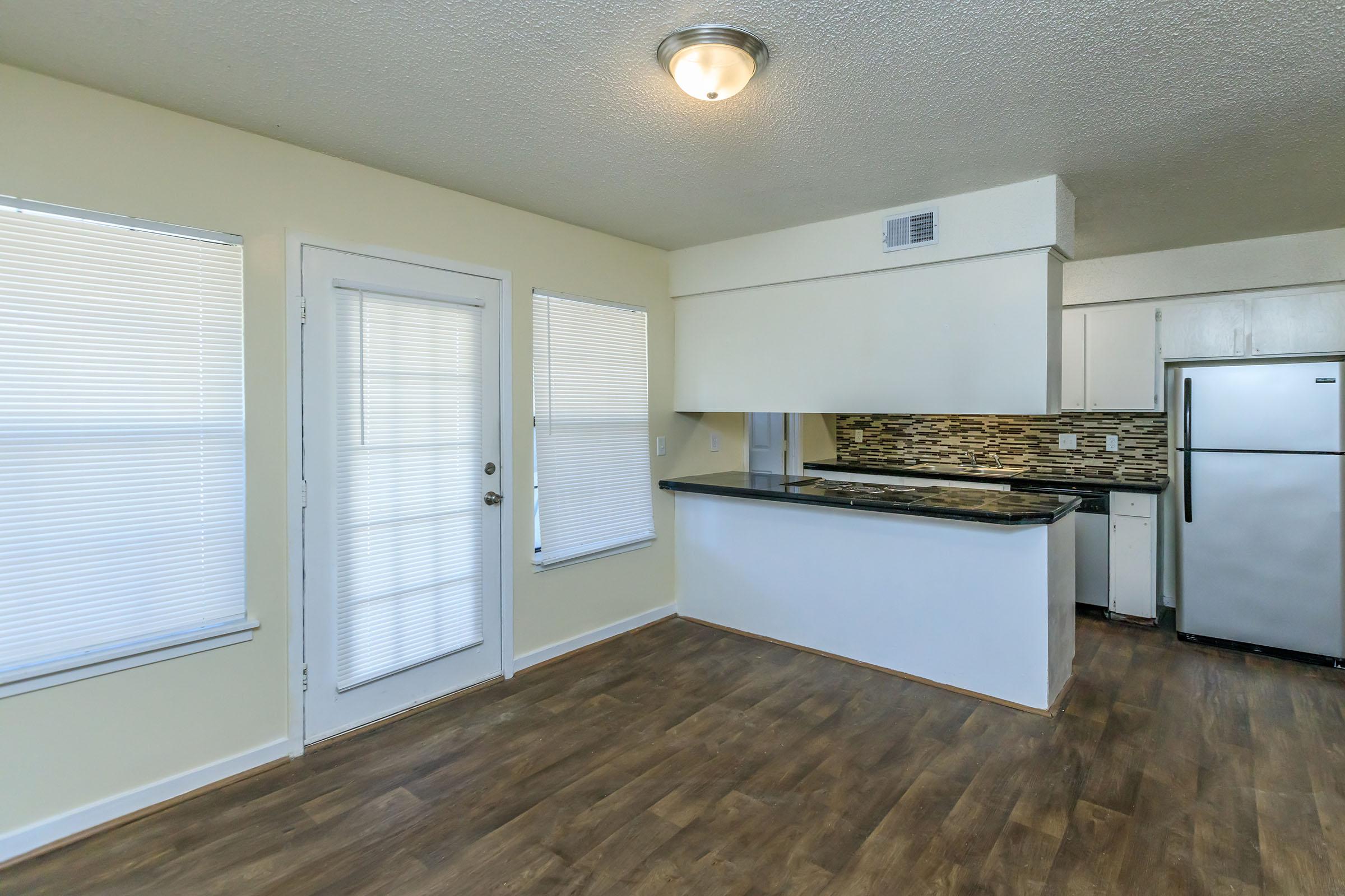 a kitchen with a wood floor