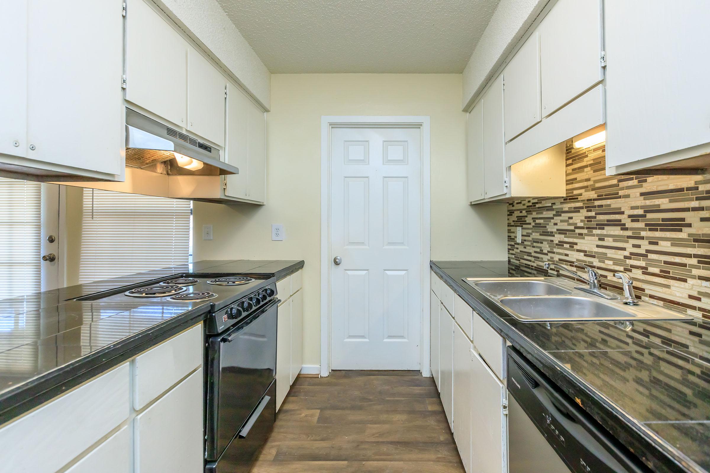 a kitchen with a building in the background