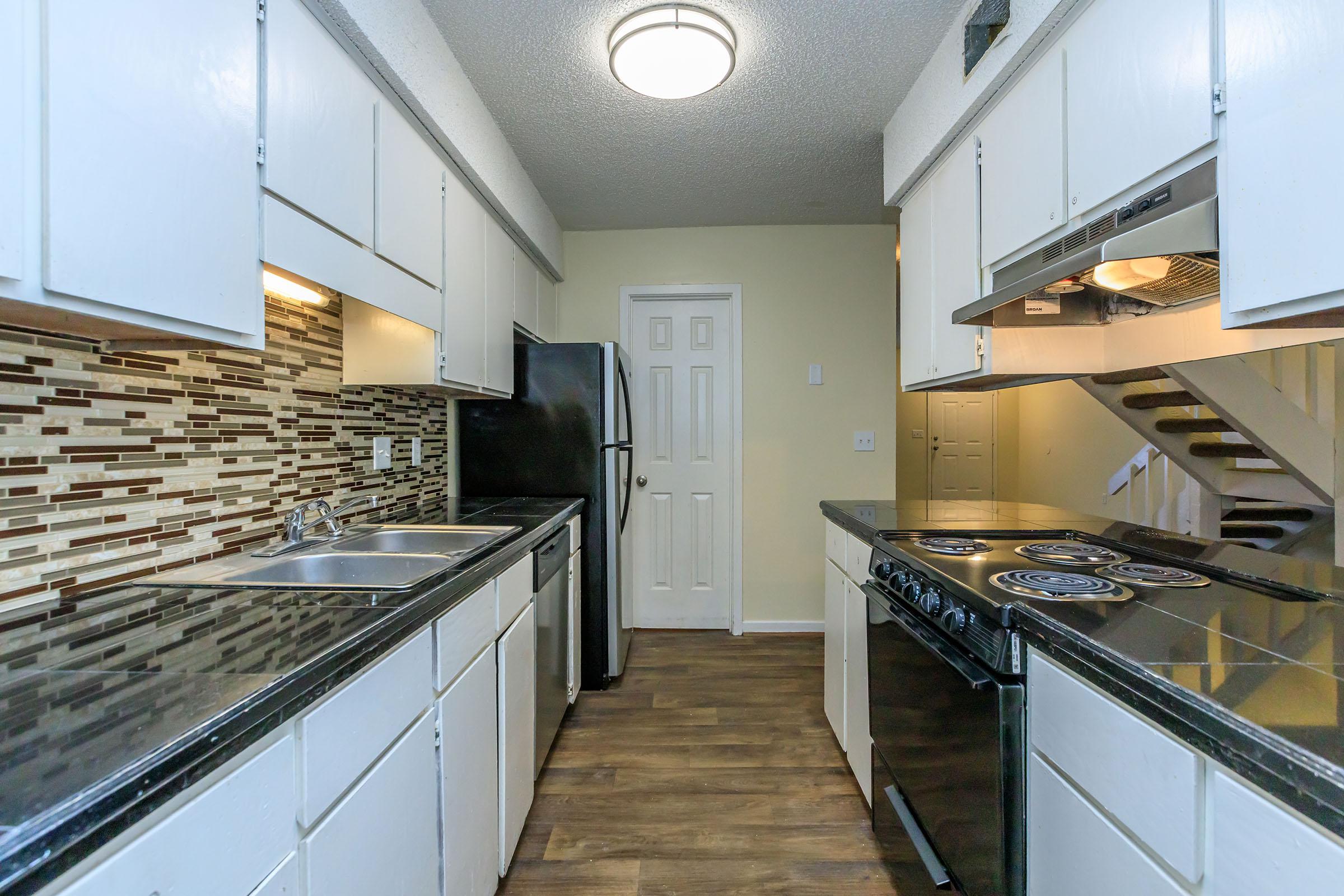 a large kitchen with stainless steel appliances