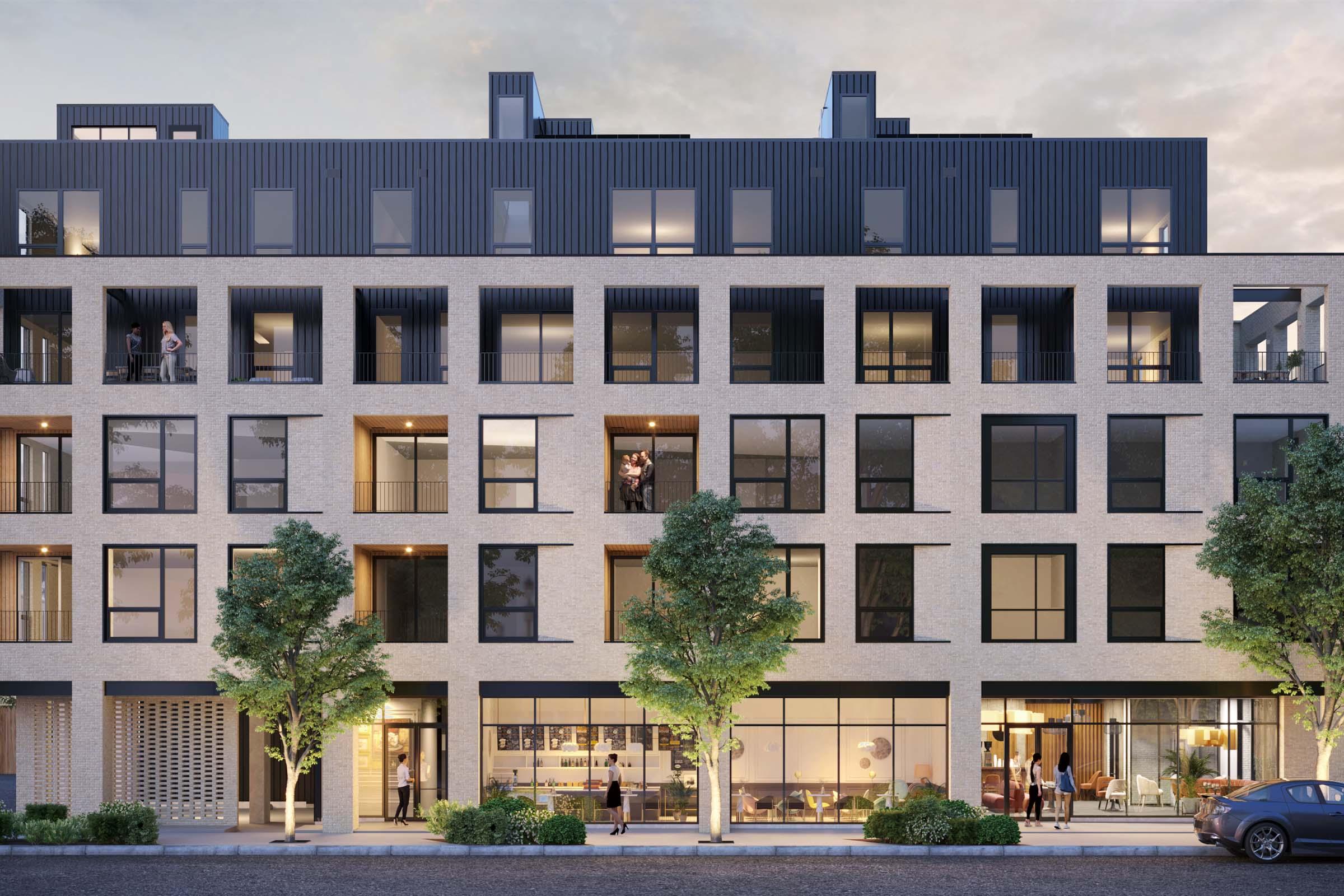 Modern architectural building featuring a mixed façade of stone and black panels. Large windows on multiple levels showcase balconies and outdoor spaces. Trees line the street, adding greenery to the urban setting. People can be seen in some windows and on the street, suggesting a vibrant community atmosphere.