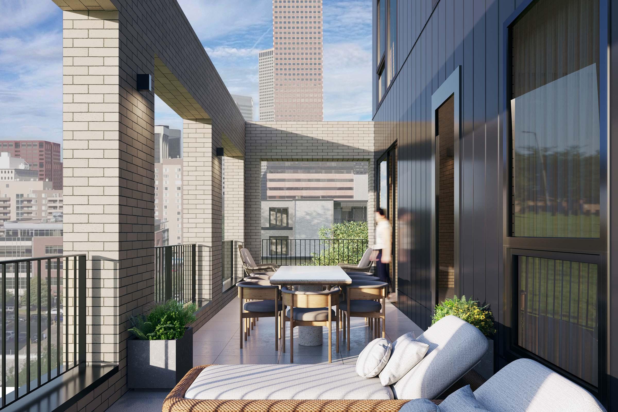 A modern balcony featuring a large dining table with chairs, a comfortable lounge chair, and potted plants. The backdrop shows a city skyline with high-rise buildings under a blue sky. The space is designed for outdoor relaxation and dining.