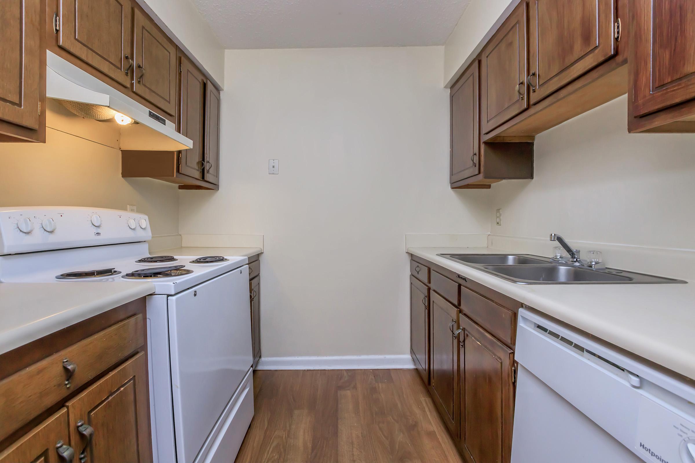 a kitchen with a stove sink and refrigerator