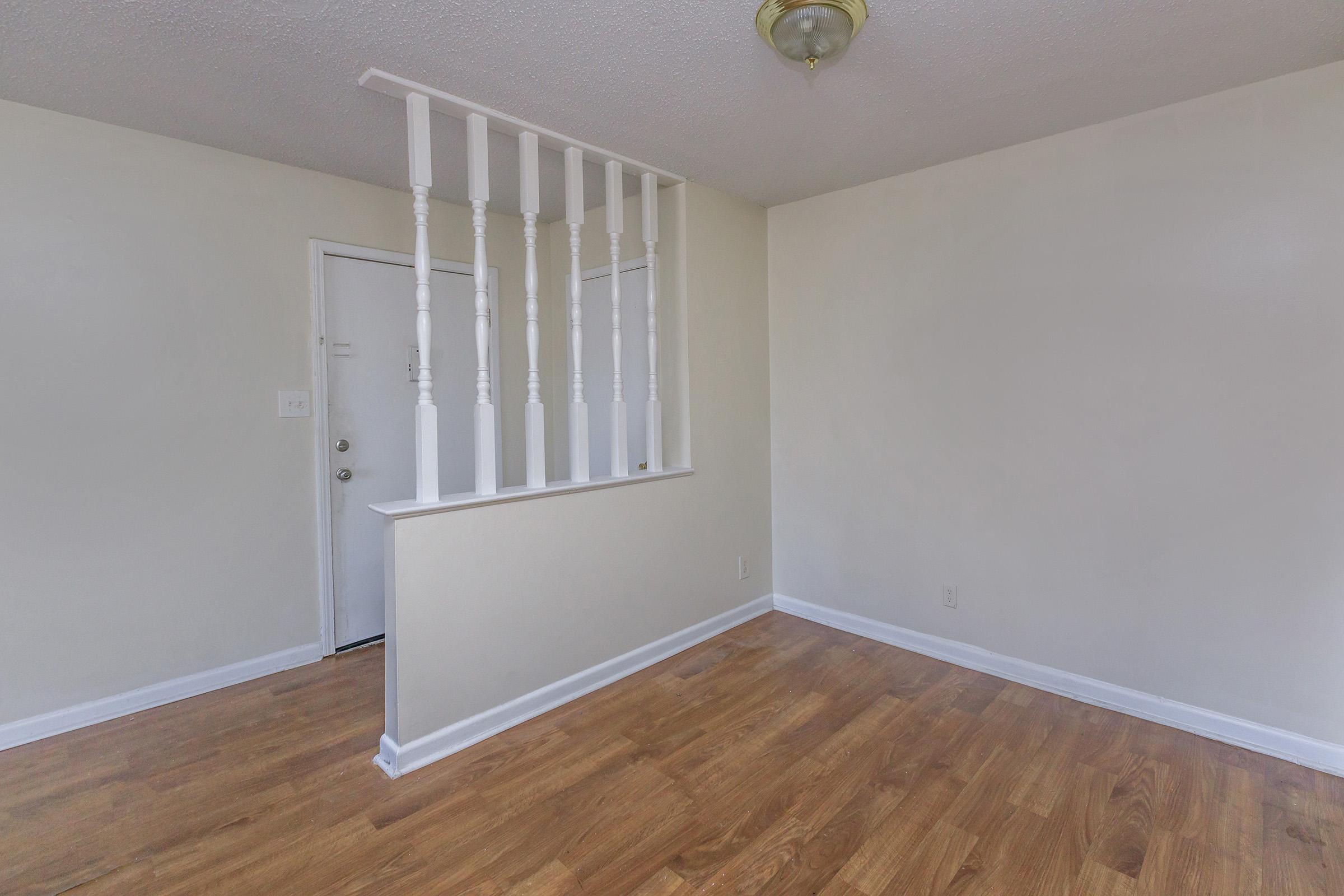 a large empty room with a wood floor