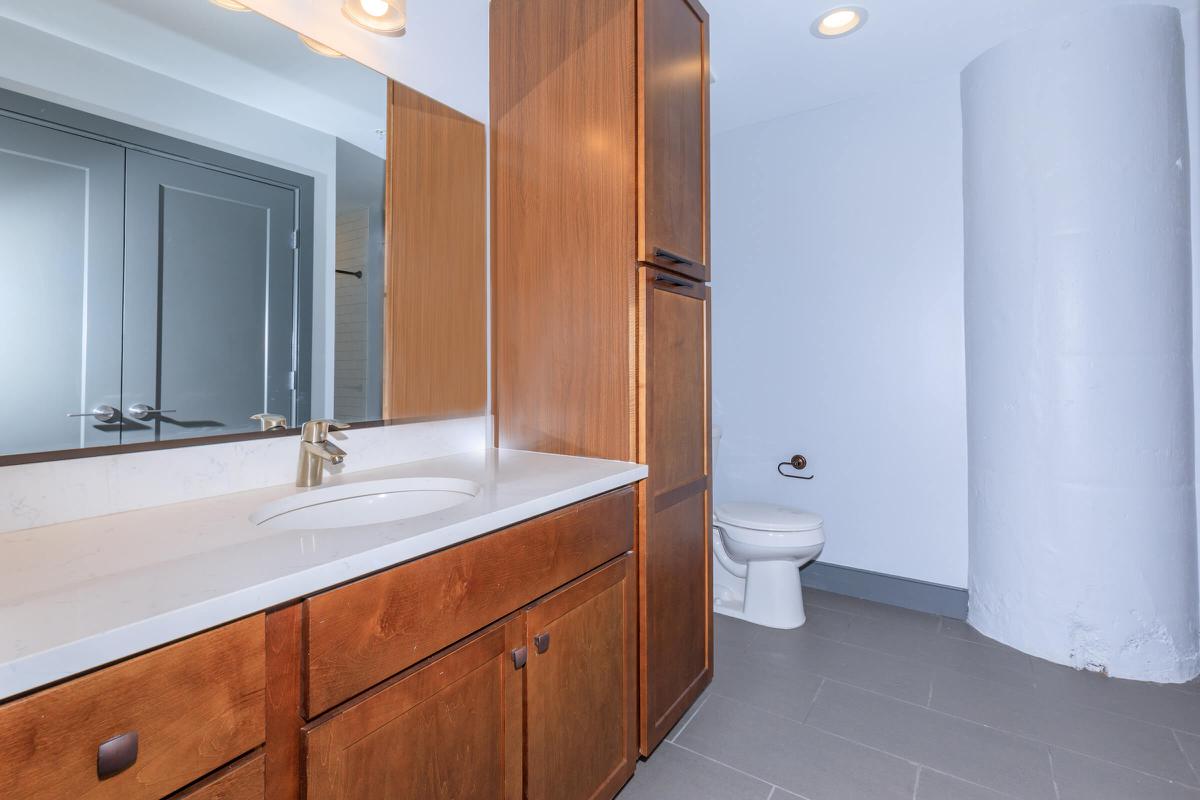 a kitchen with a sink and a mirror