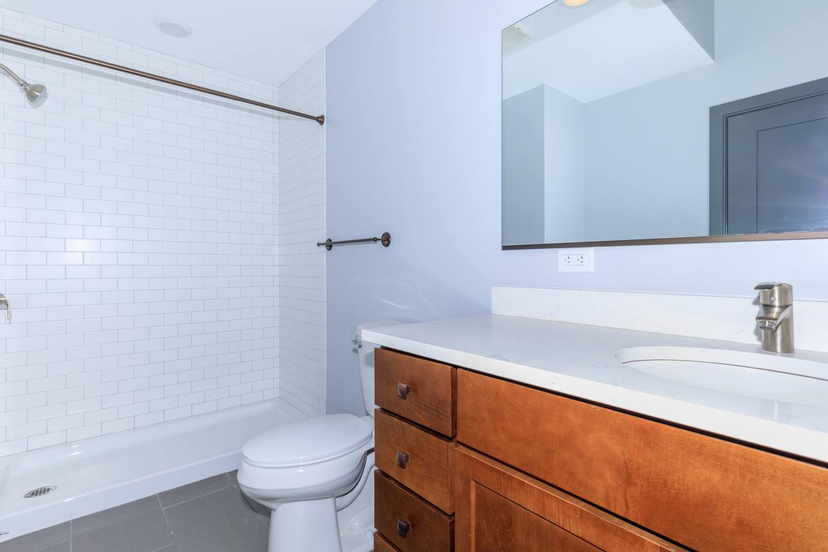 a white sink sitting next to a shower