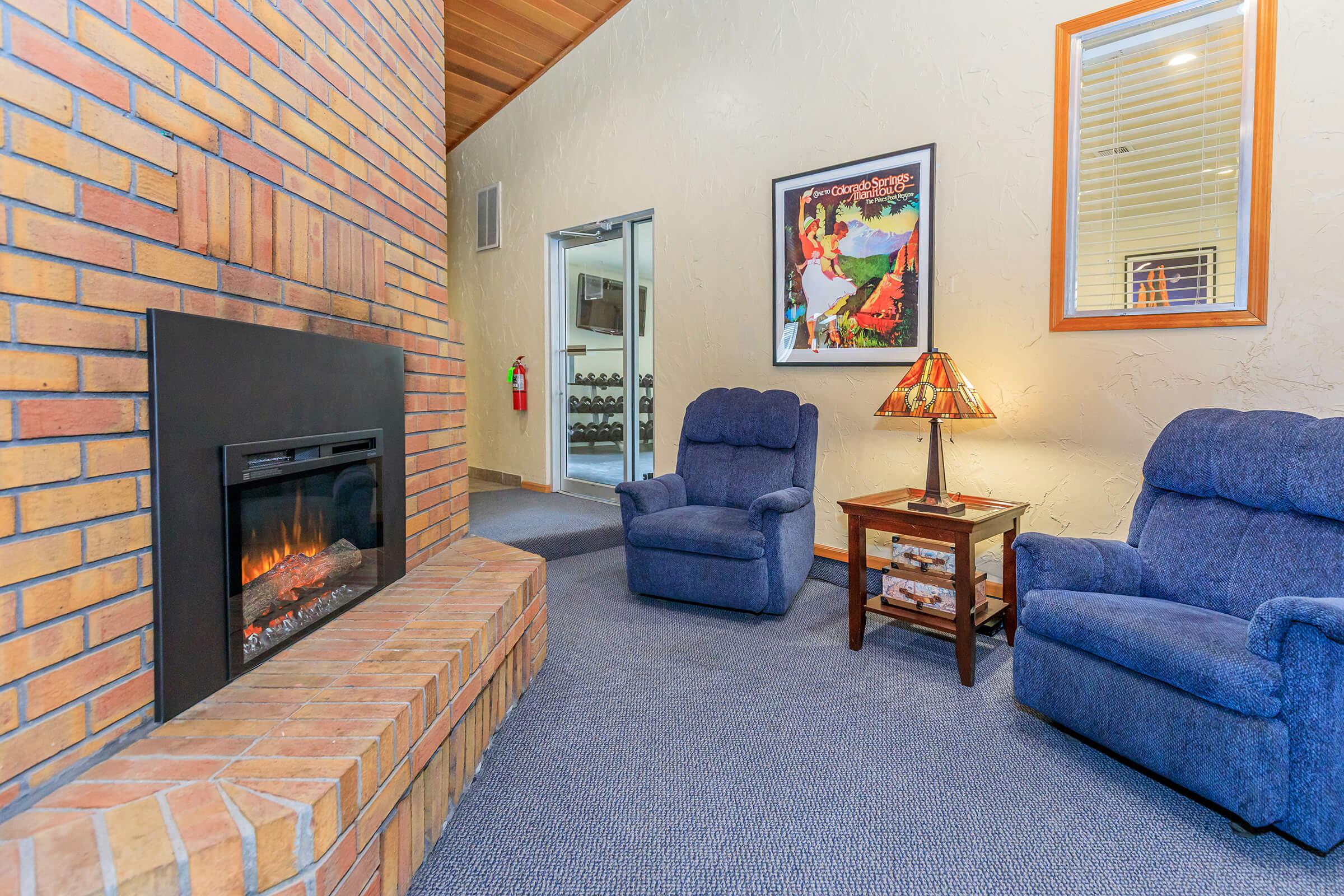 a living room filled with furniture and a fire place