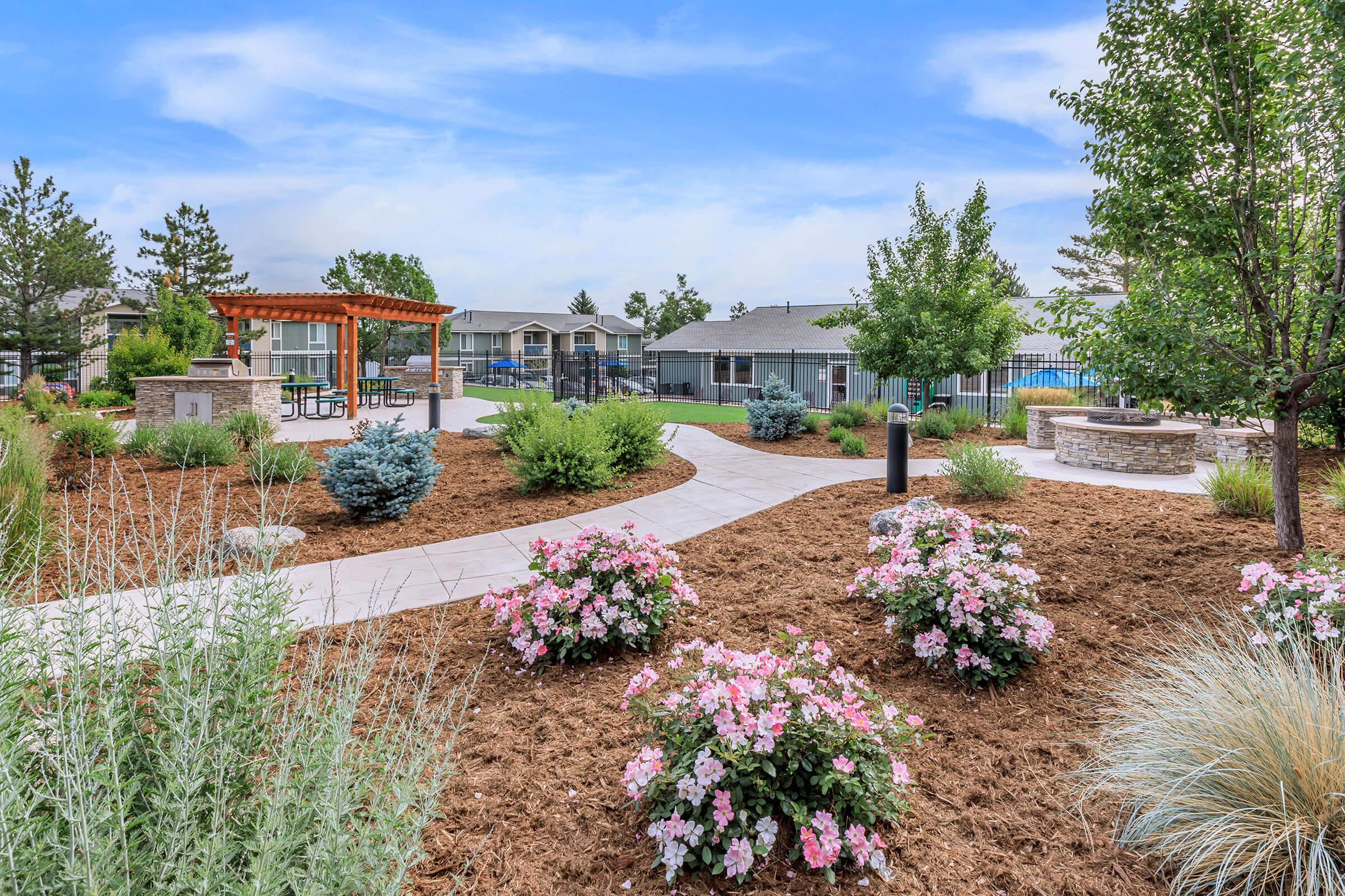 a close up of a flower garden in front of a building