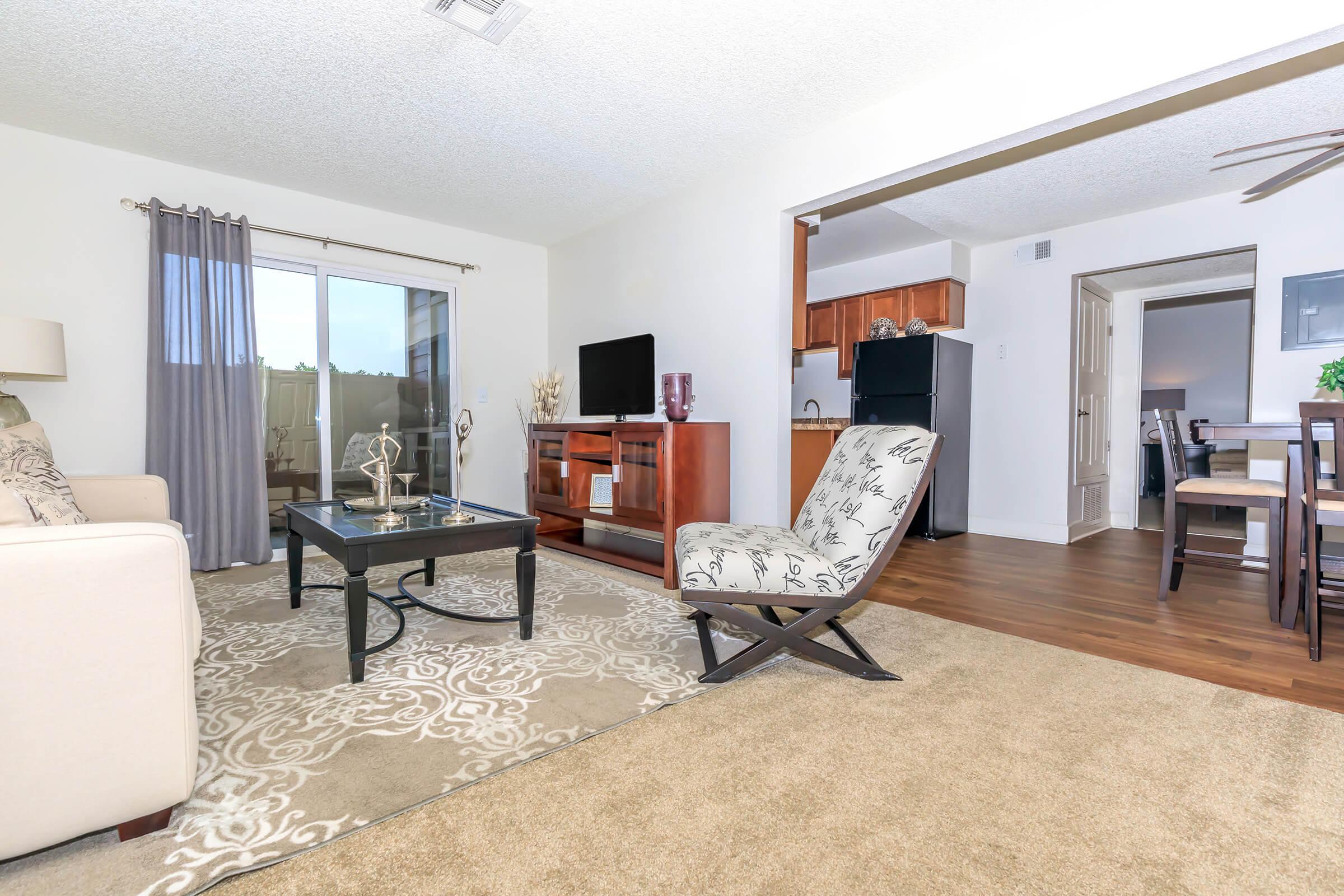 a living room filled with furniture and a large window