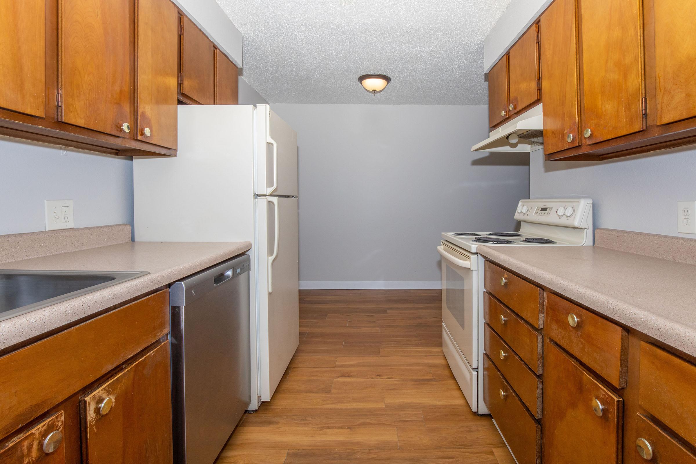 a kitchen with stainless steel appliances and wooden cabinets