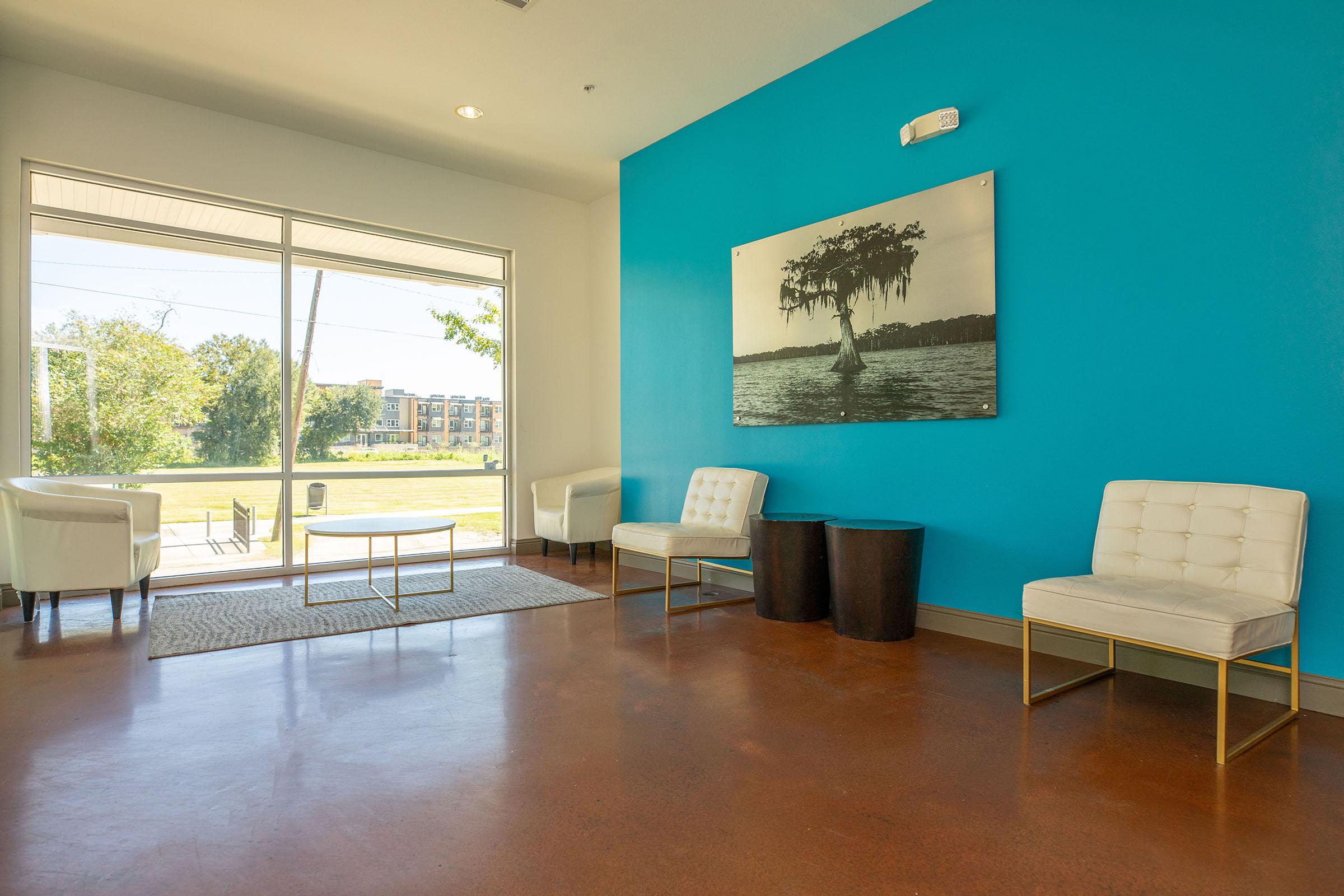 a living room filled with furniture and a large window