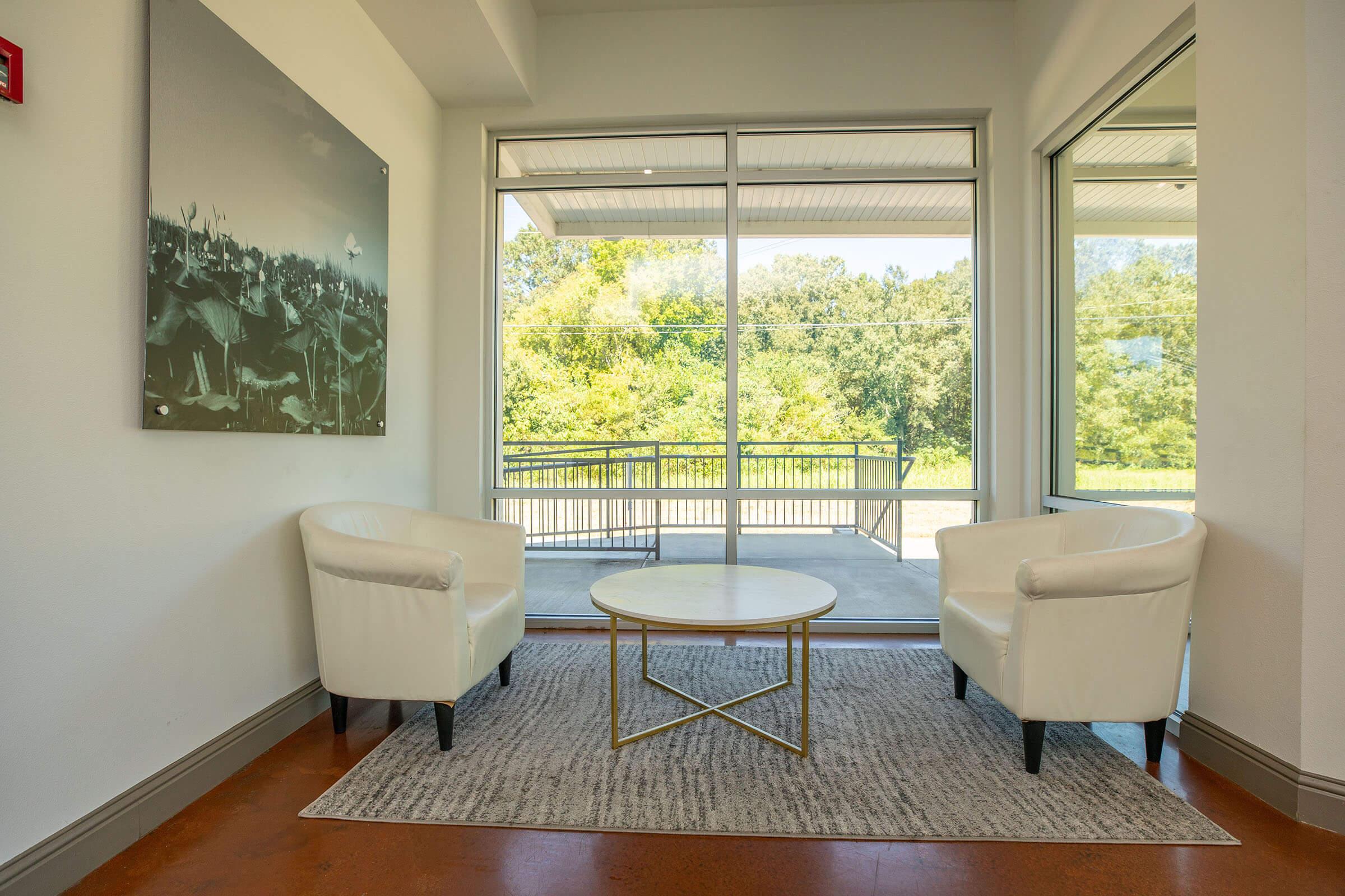 a view of a living room filled with furniture and a large window