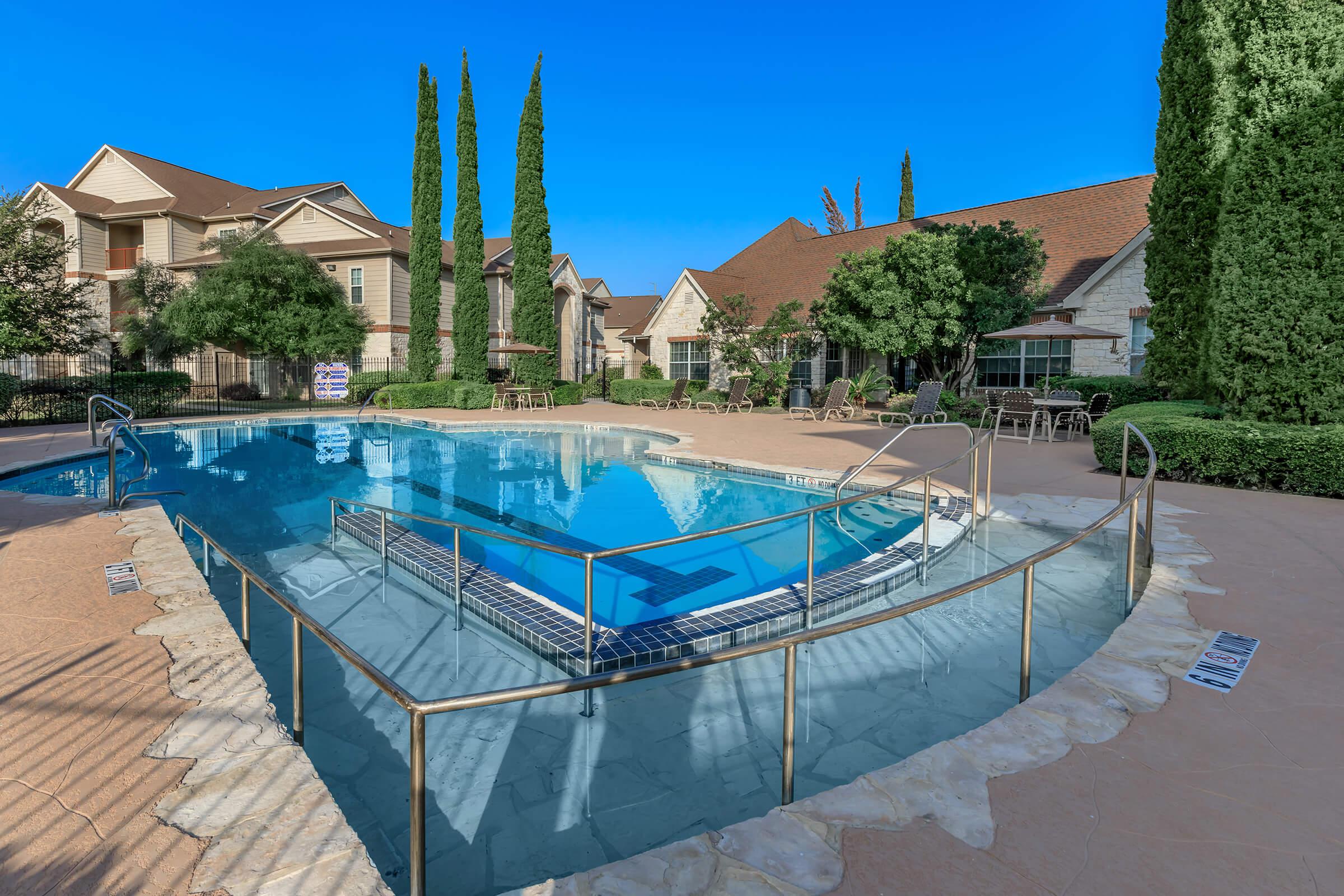 a large brick building with a pool in front of a house