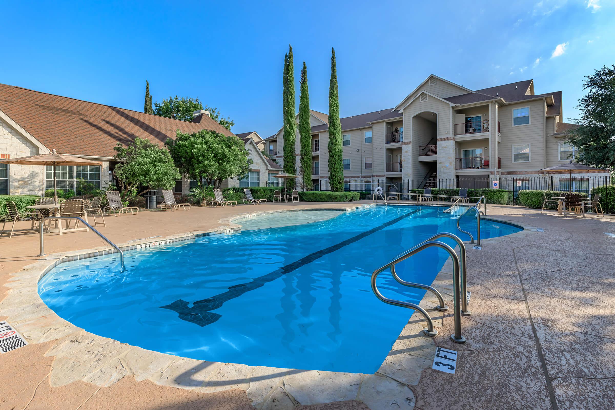 a blue pool of water in front of a house