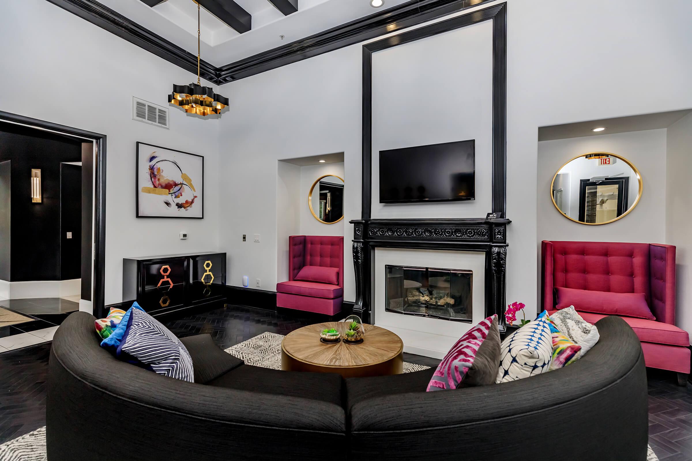 Community room with a couch in front of the fireplace