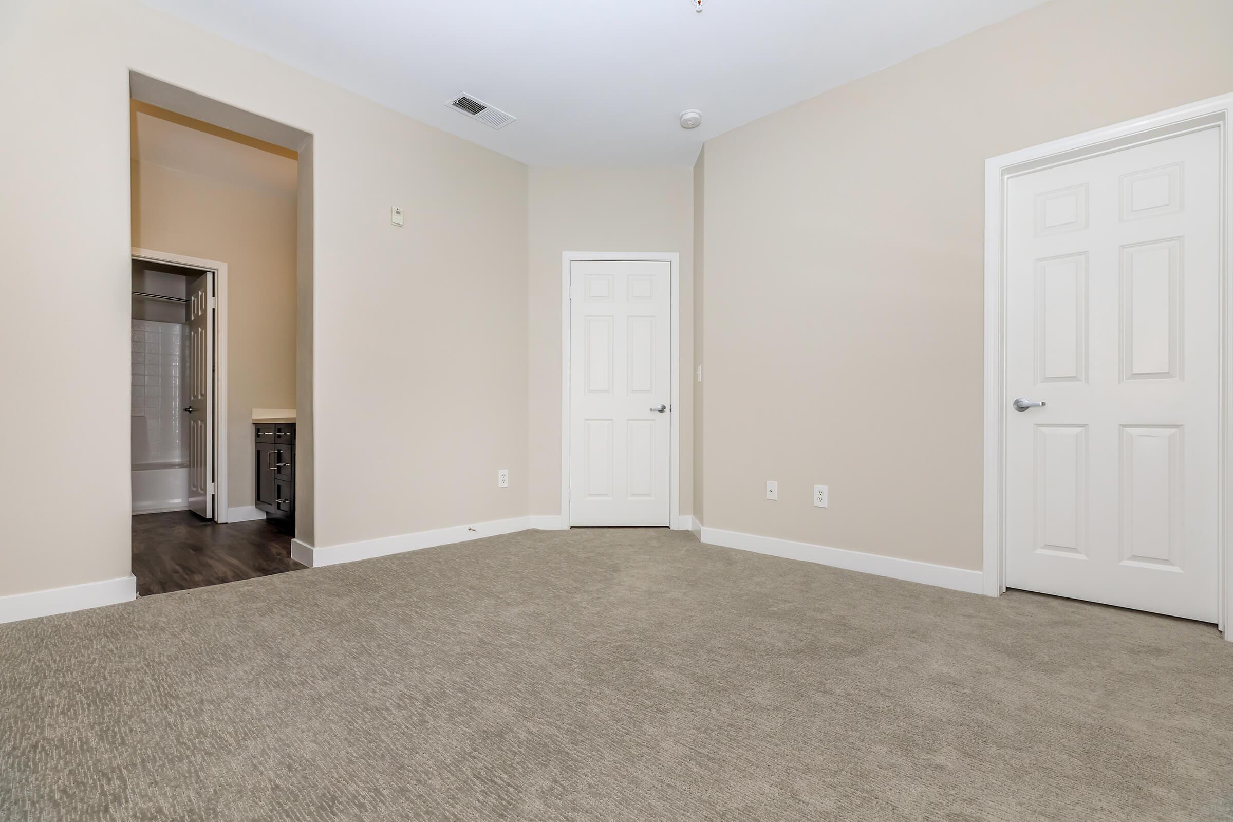 Bedroom with open bathroom door