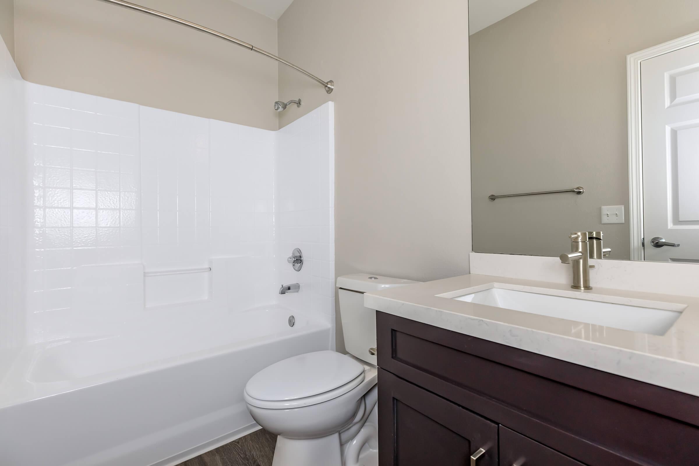 Unfurnished bathroom with wooden cabinets