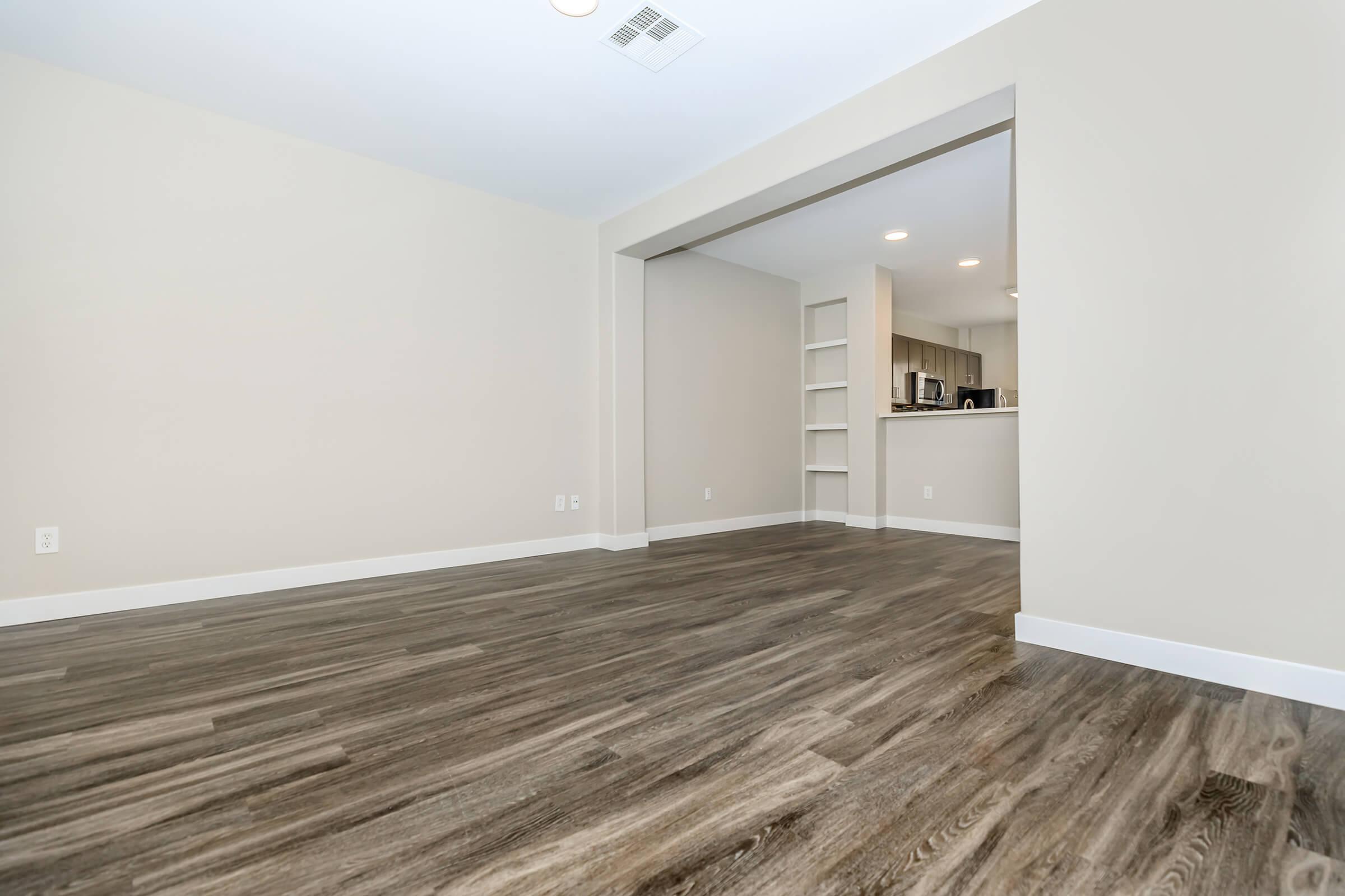 Unfurnished living room with wooden floors