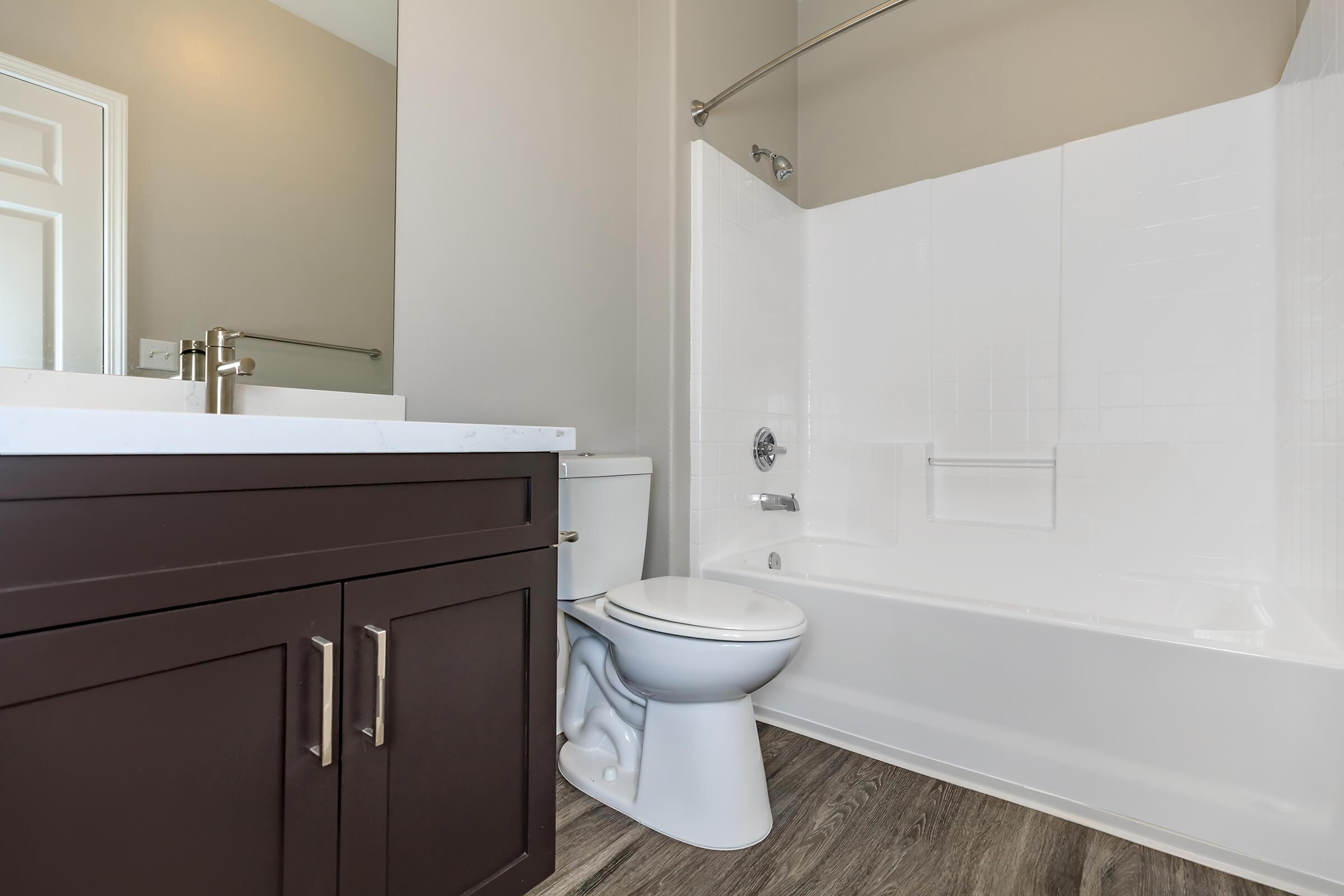 Vacant bathroom with wooden floors