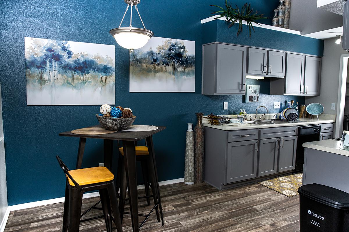a kitchen with a table and chairs