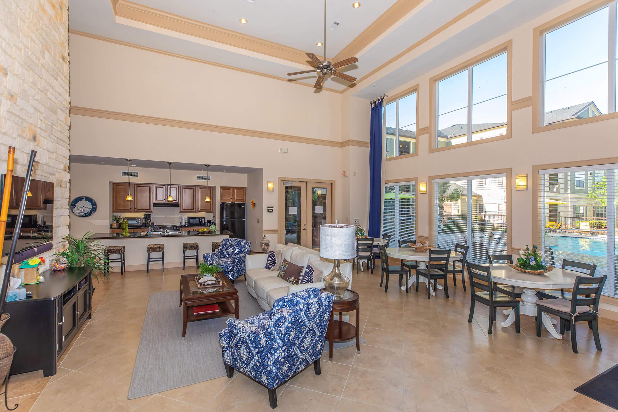 a living room filled with furniture and a large window