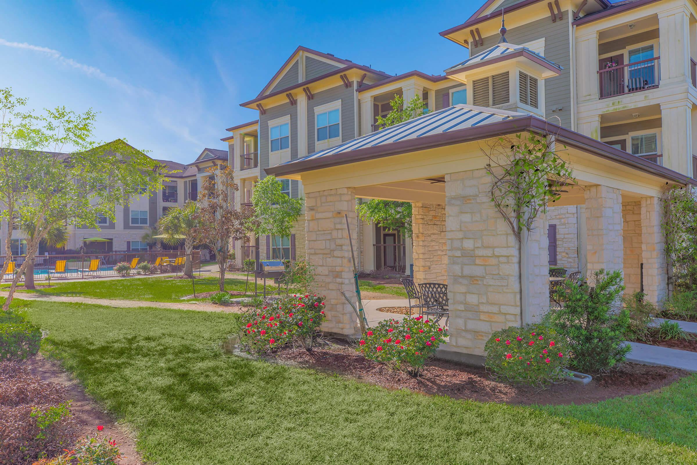 a close up of a flower garden in front of a building