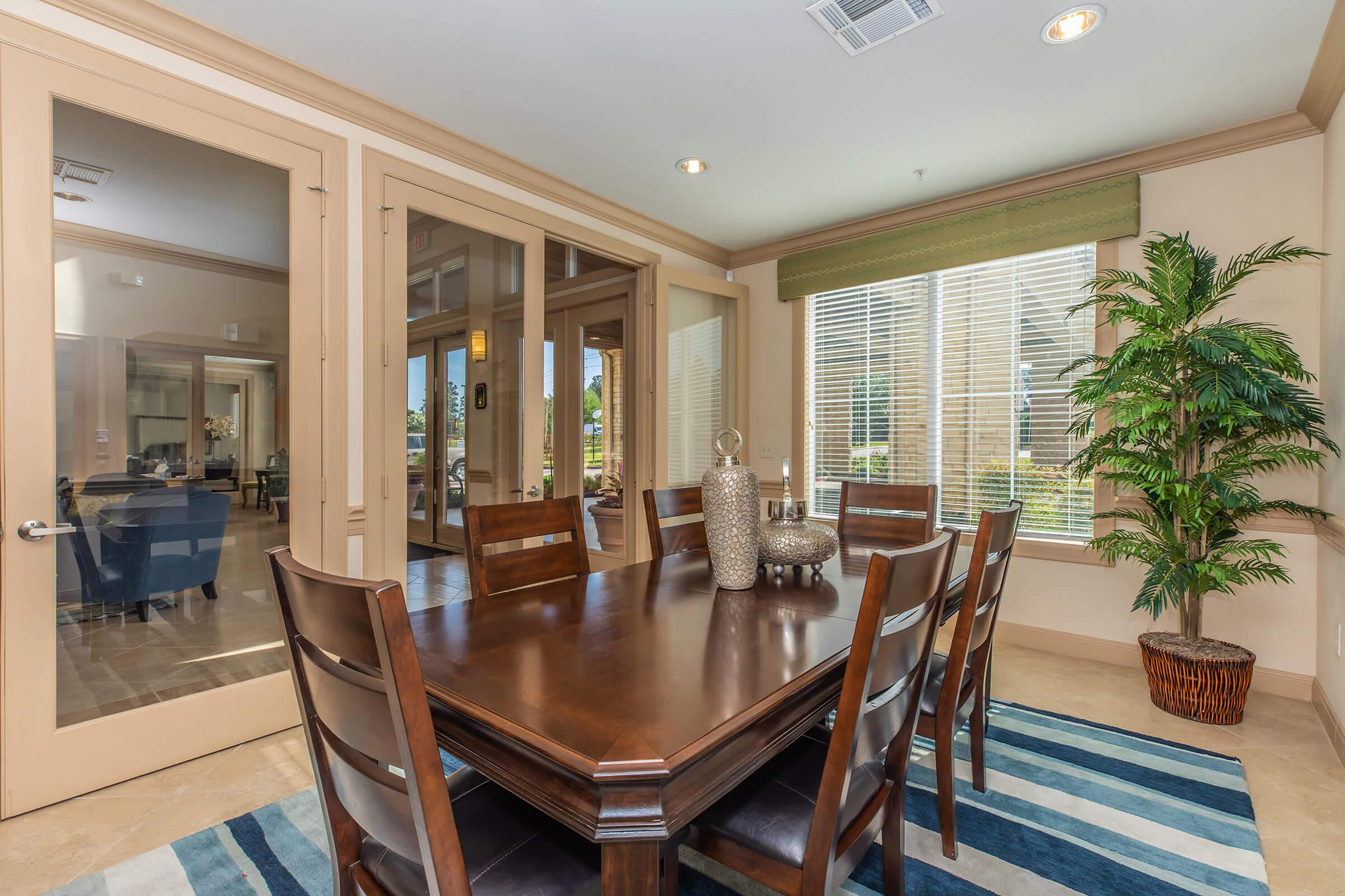 a living room filled with furniture and a large window