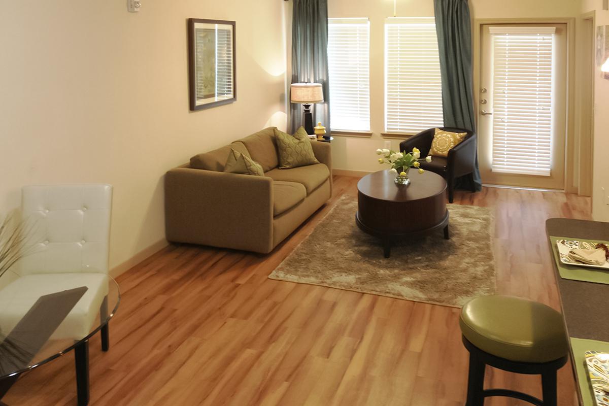 a living room filled with furniture and a large window