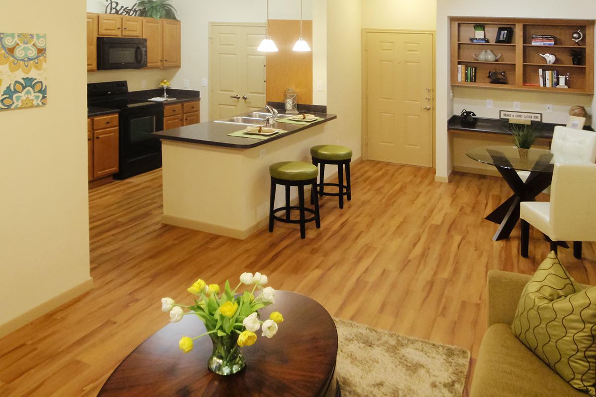 a living room filled with furniture on top of a hard wood floor