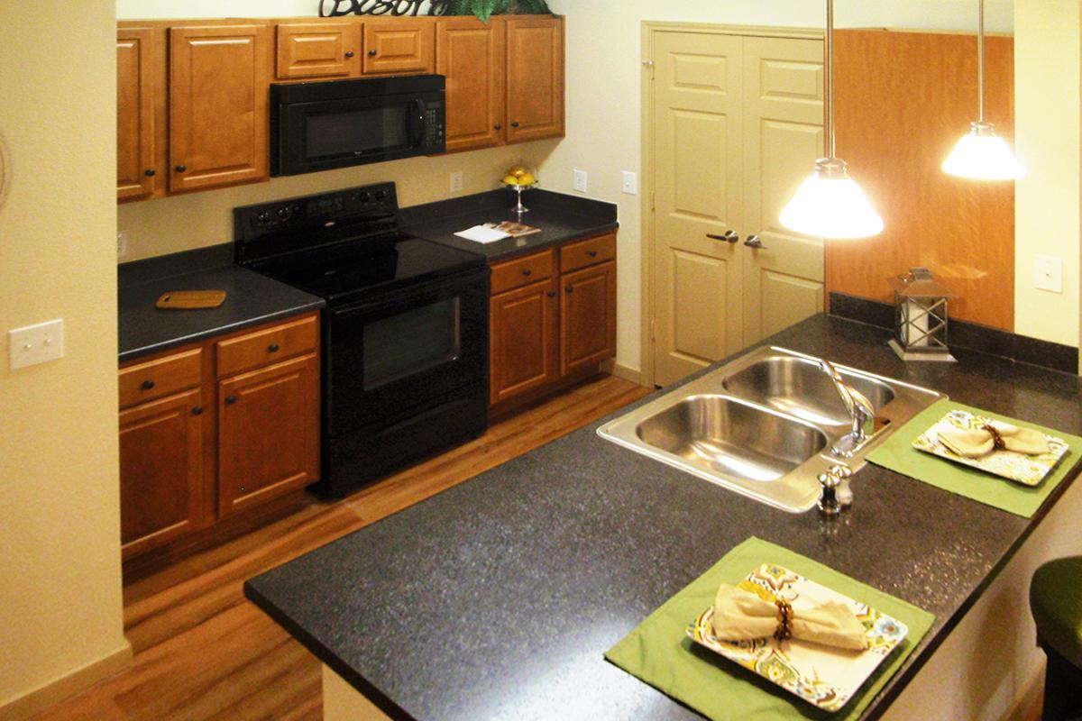 a kitchen with stainless steel appliances and wooden cabinets