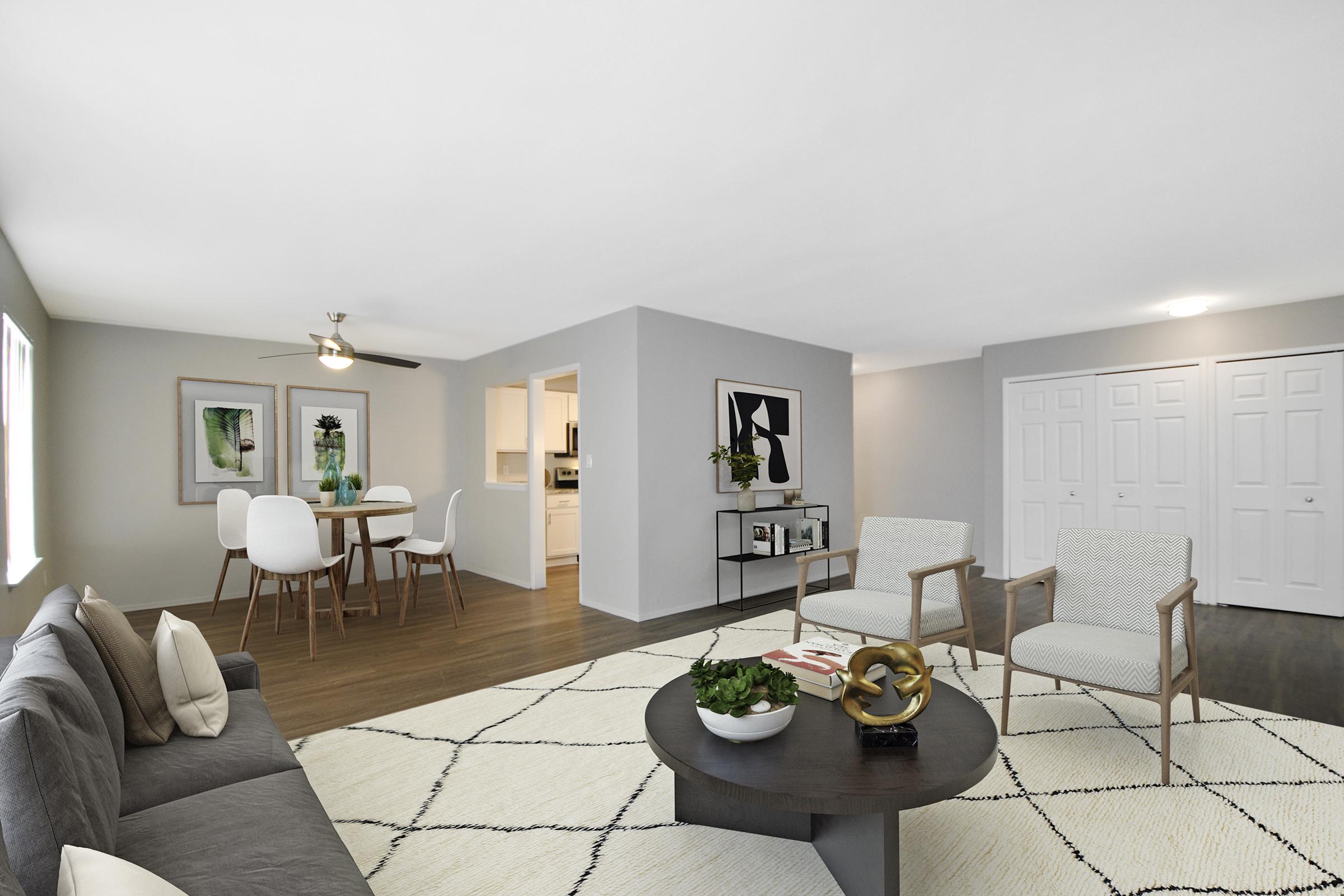 a living room filled with furniture and a table