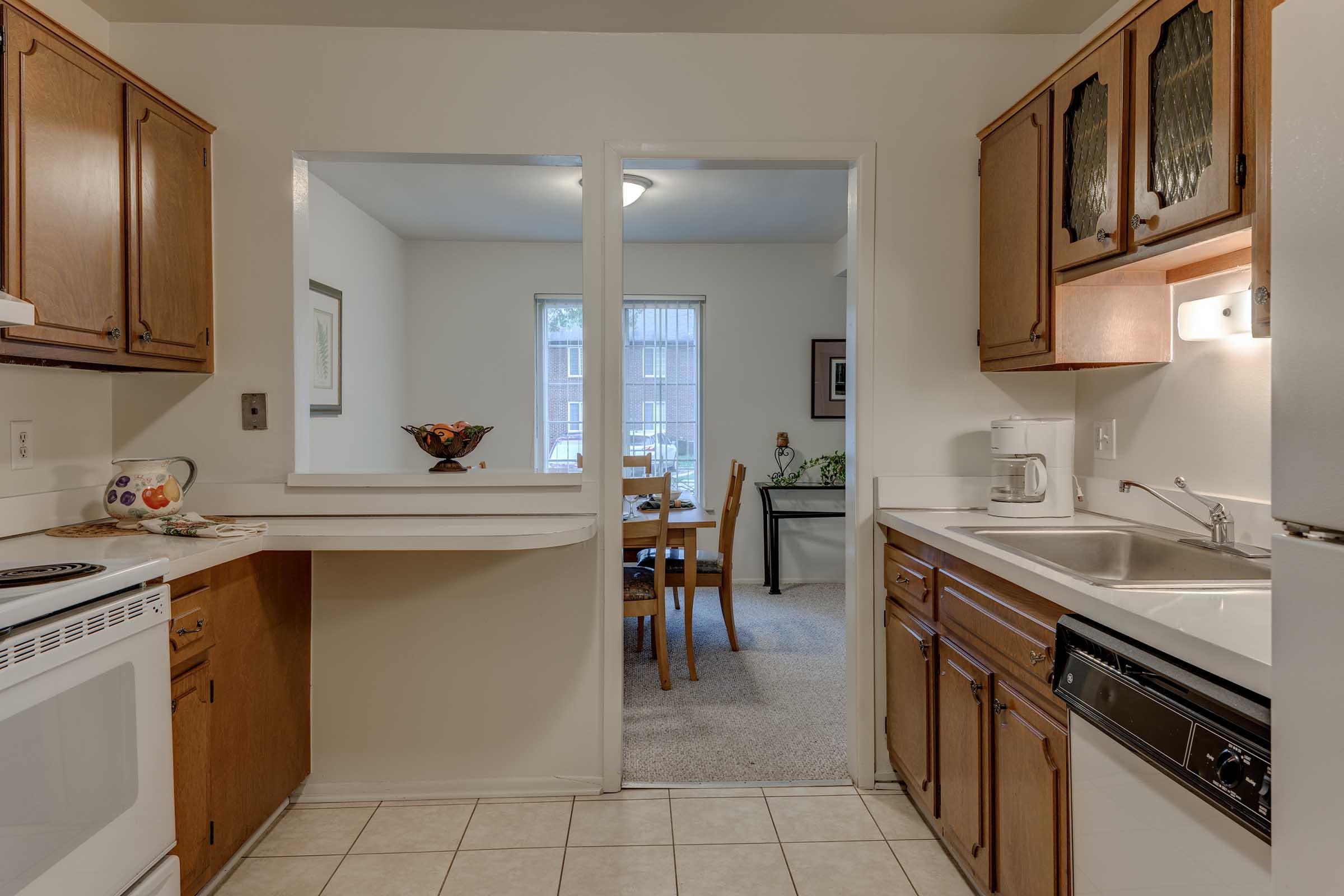 a kitchen with a sink and a mirror