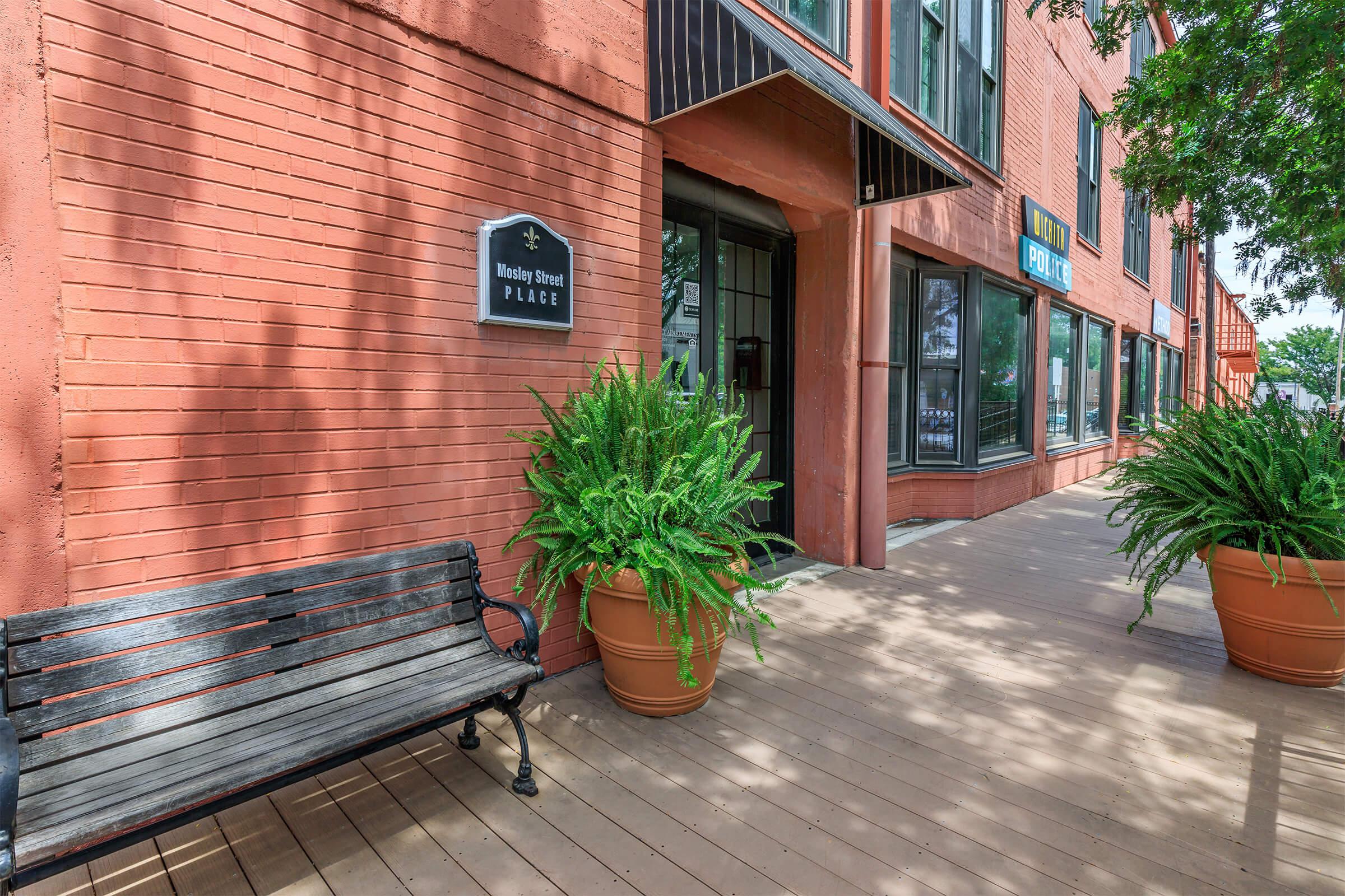 a bench in front of a brick building