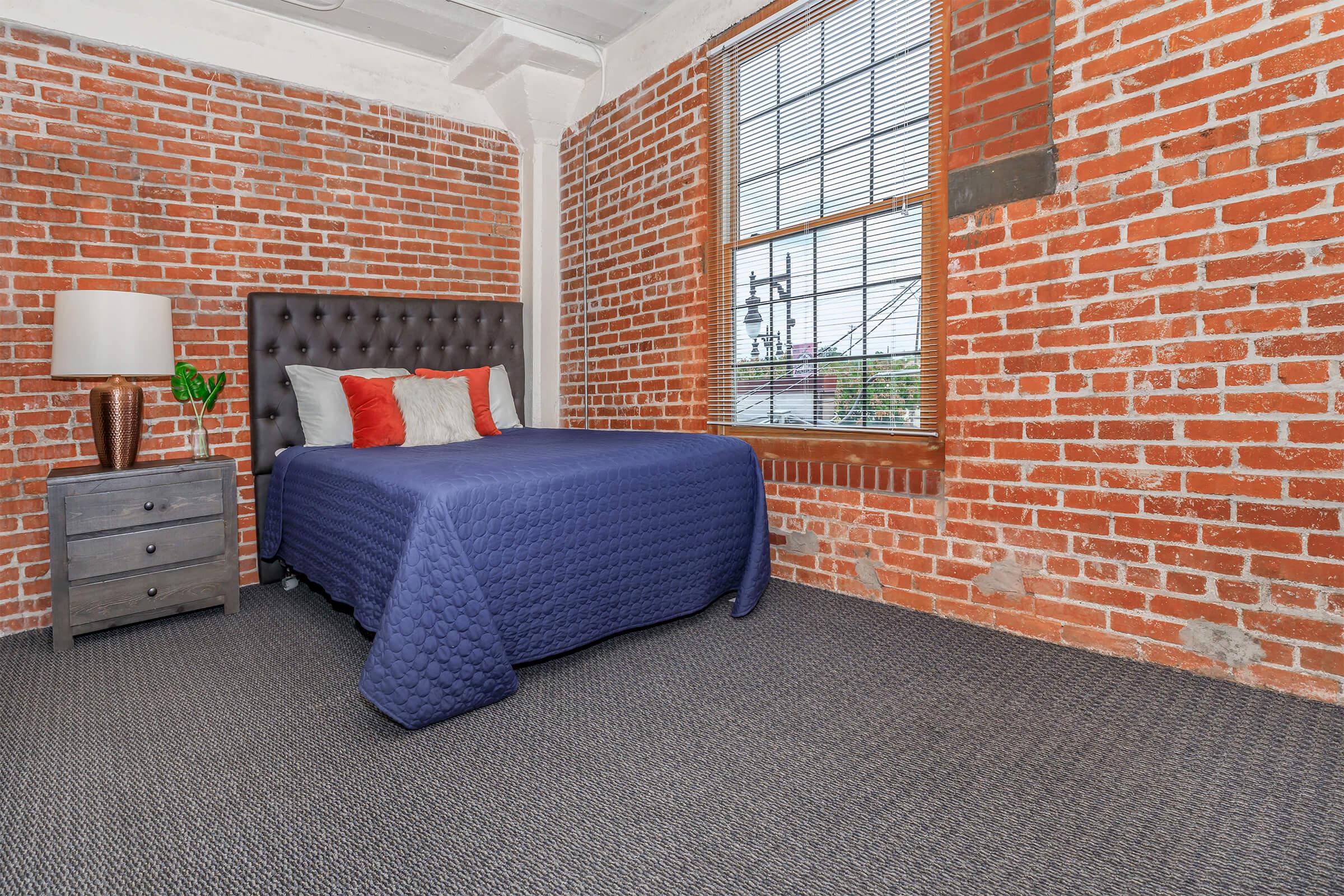 a living room with a brick wall