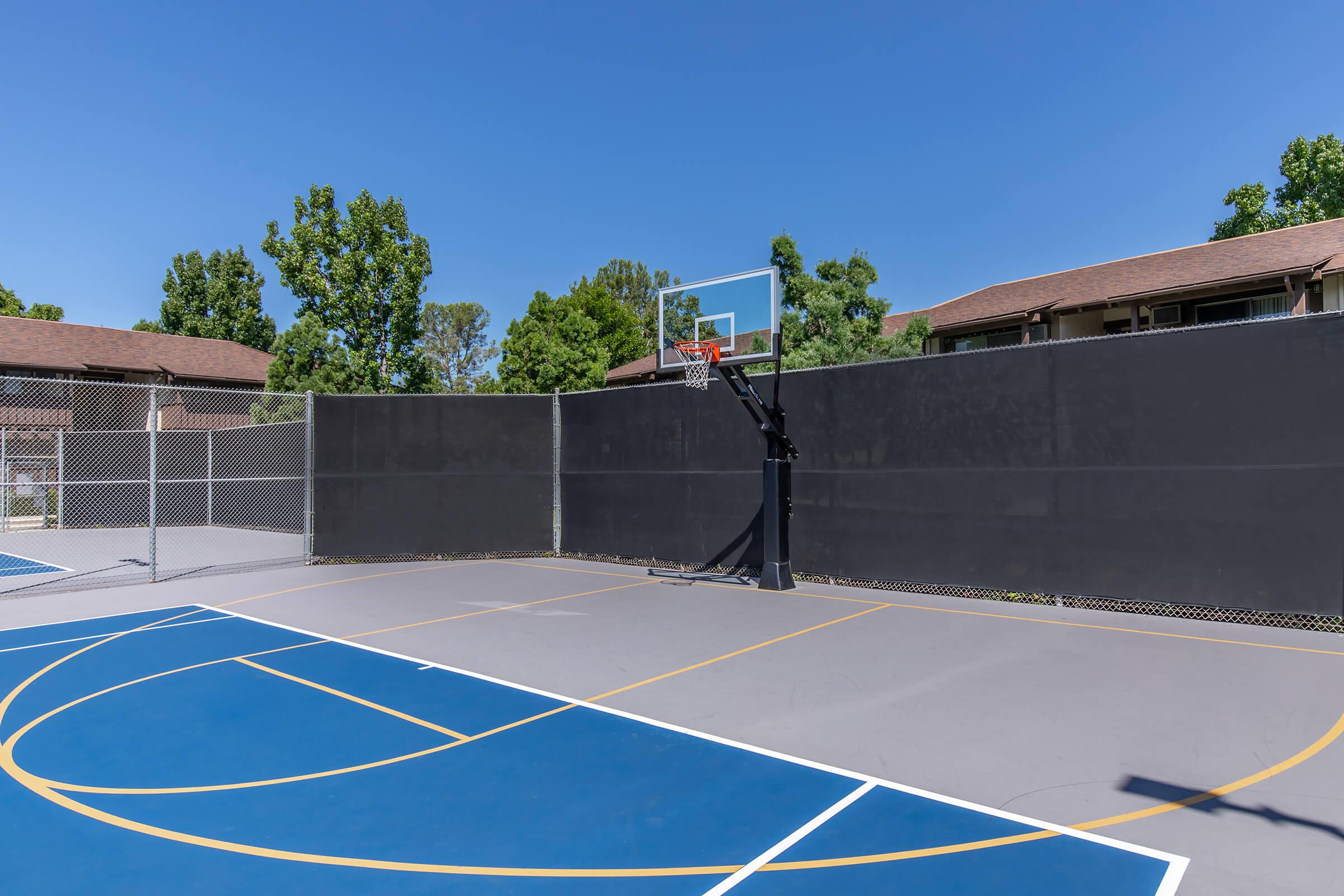 a basketball on a court with a racket