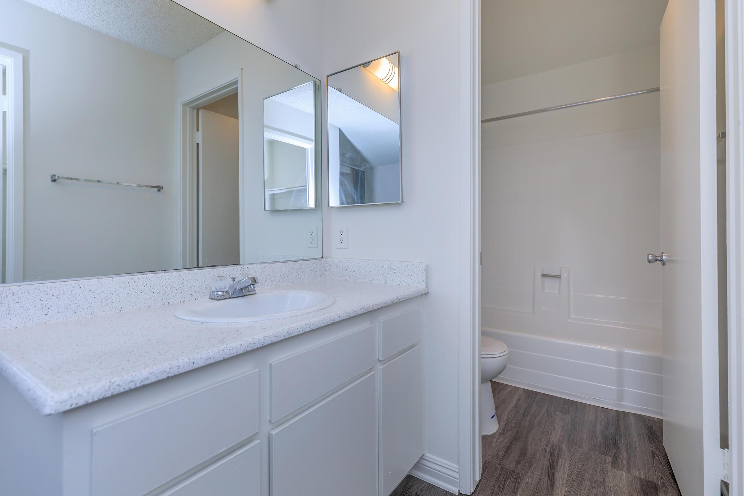 Bathroom sink with open door to bathroom