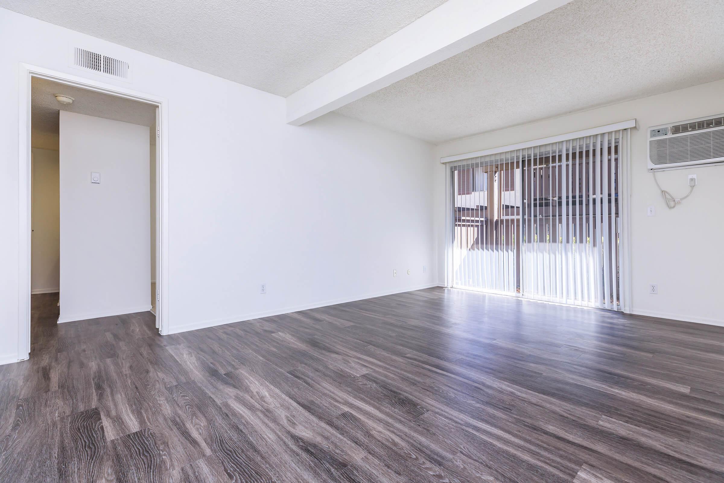 Living room with wooden floors and sliding glass doors