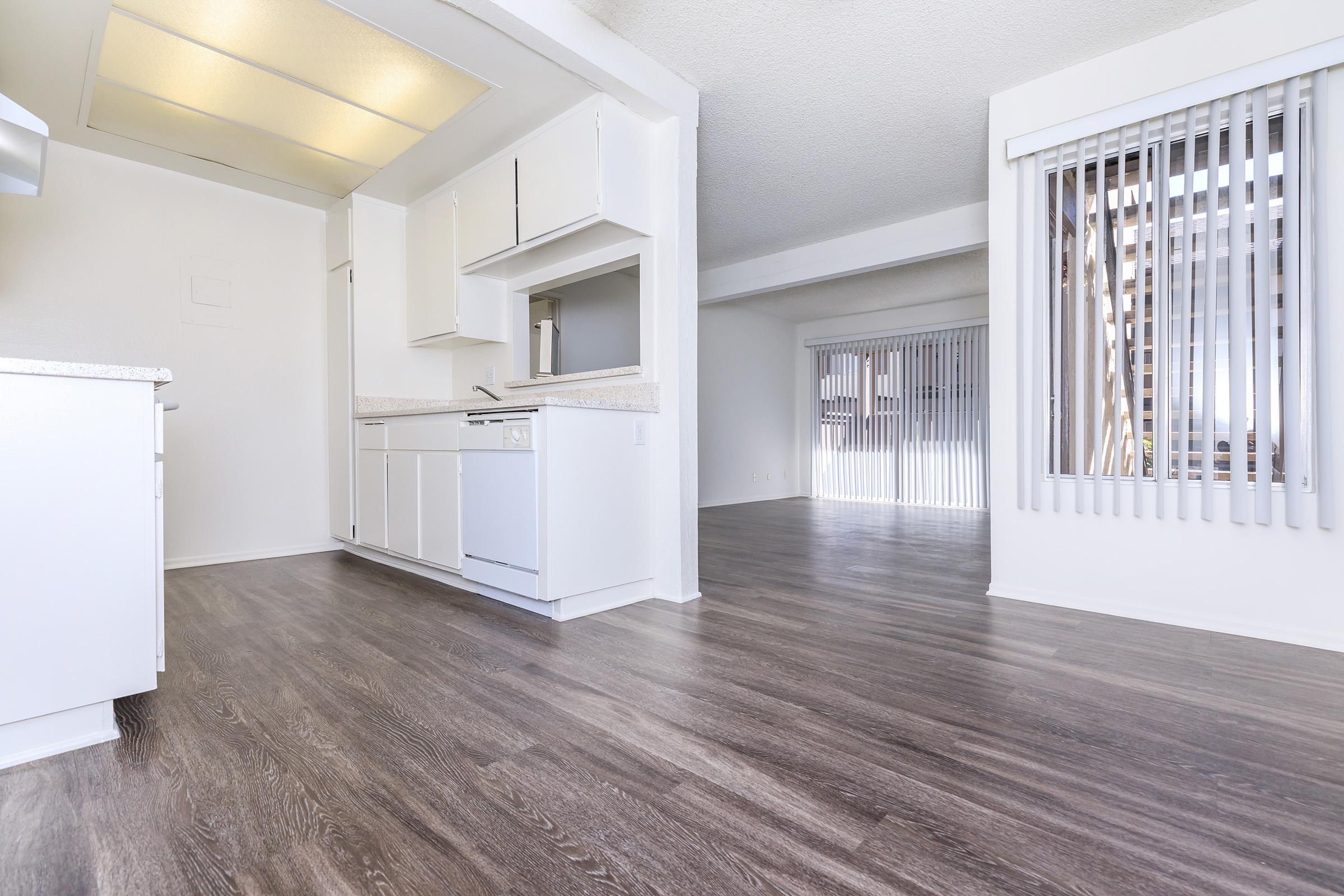 Dining room and kitchen with wooden floors