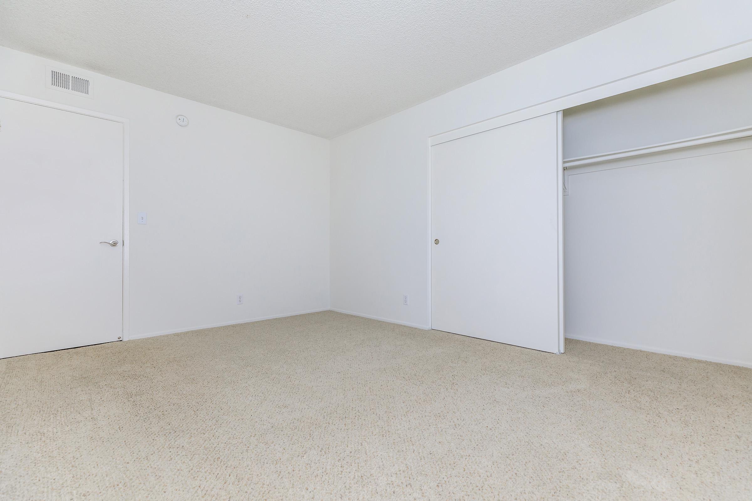 Unfurnished bedroom with open sliding closet door