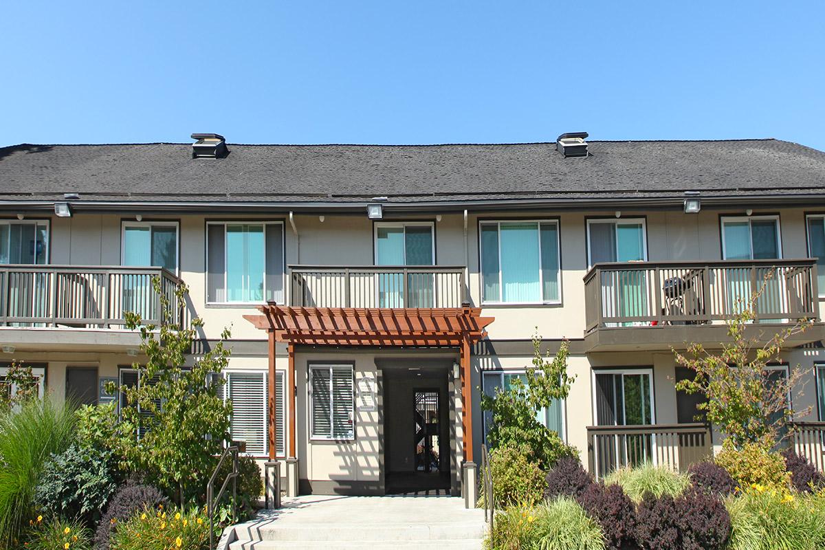 a house in front of a brick building