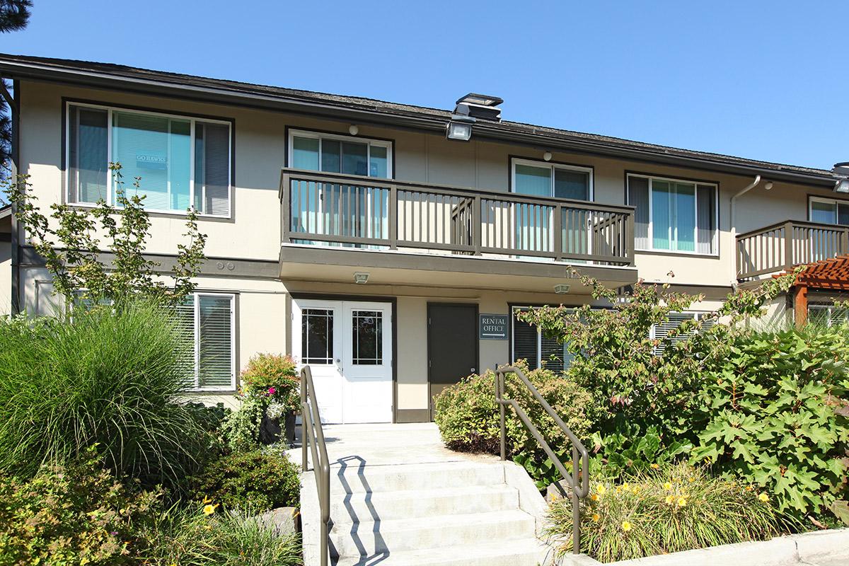 a house with bushes in front of a building