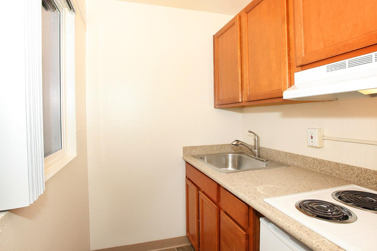 a kitchen with a stove a sink and a microwave