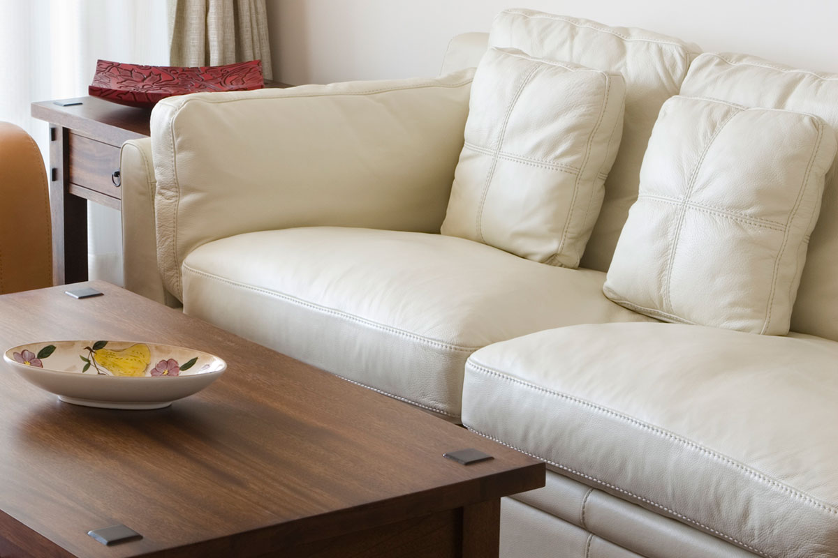 a hotel room with a couch and a table