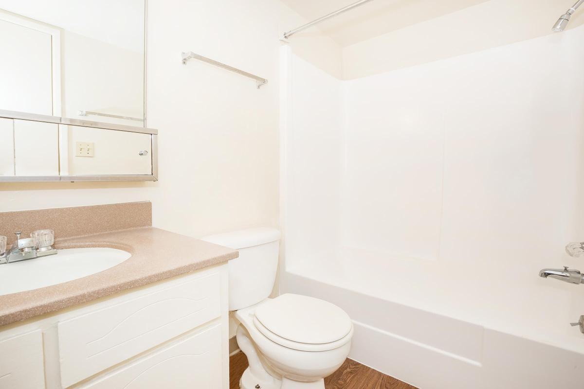 a white tub sitting next to a sink