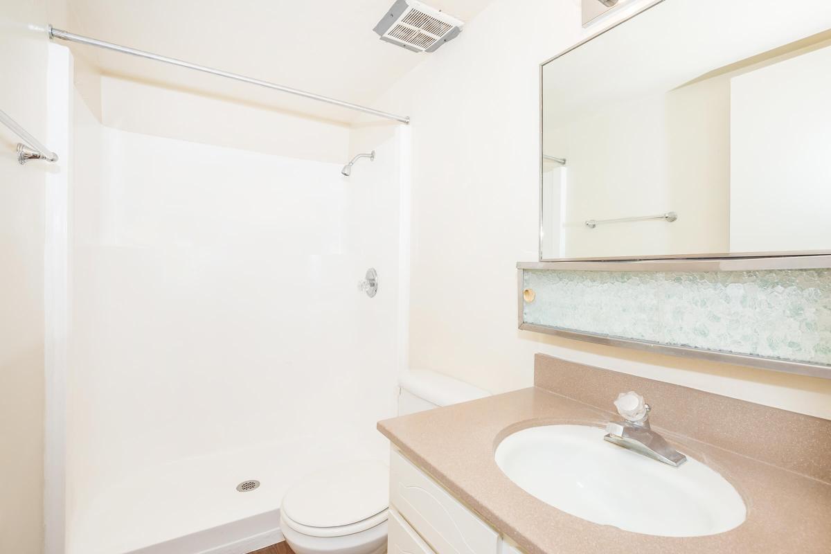 a white sink and a mirror