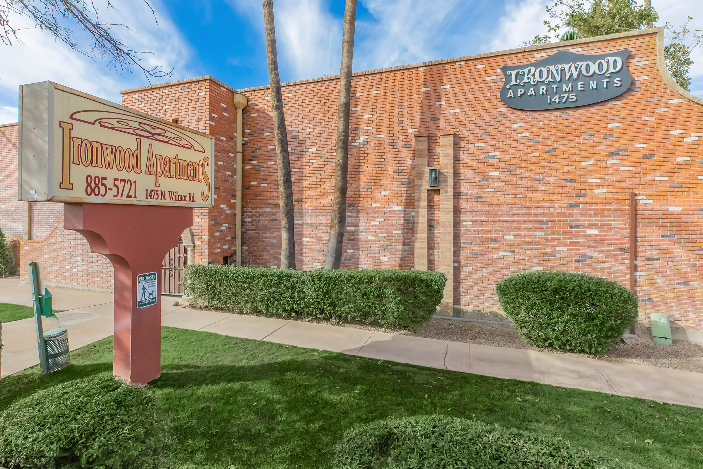 a sign in front of a brick building